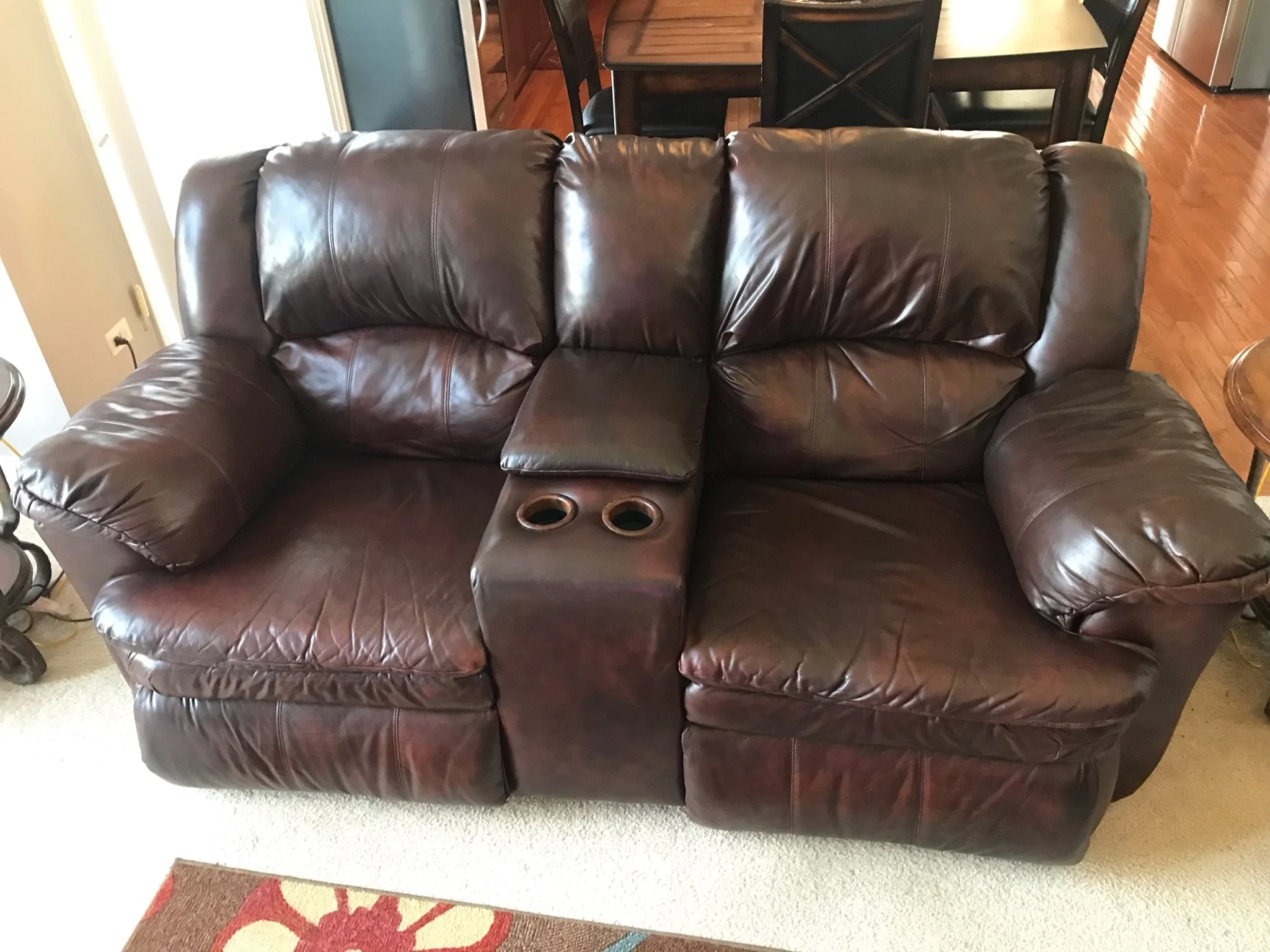 After Photo of loveseat. The leather furniture has been cleaned, refinished, and sealed. The dye has been reapplied refreshing the whole piece. Work performed in home outside of Sugar Grove, IL