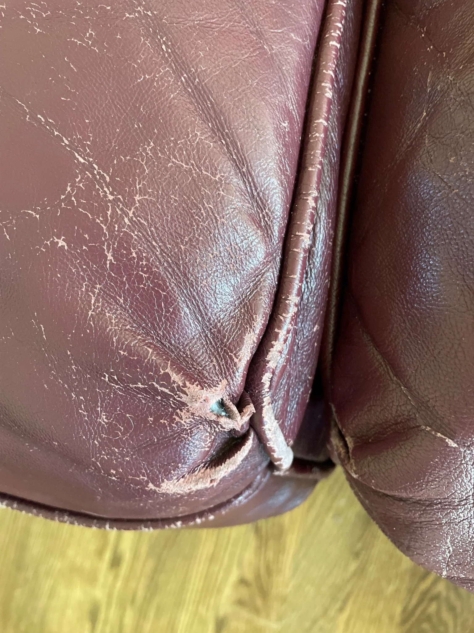 Pipping around the boxing of a leather seat cushion is often the first thing to fall apart and start forming small tears and holes. 
