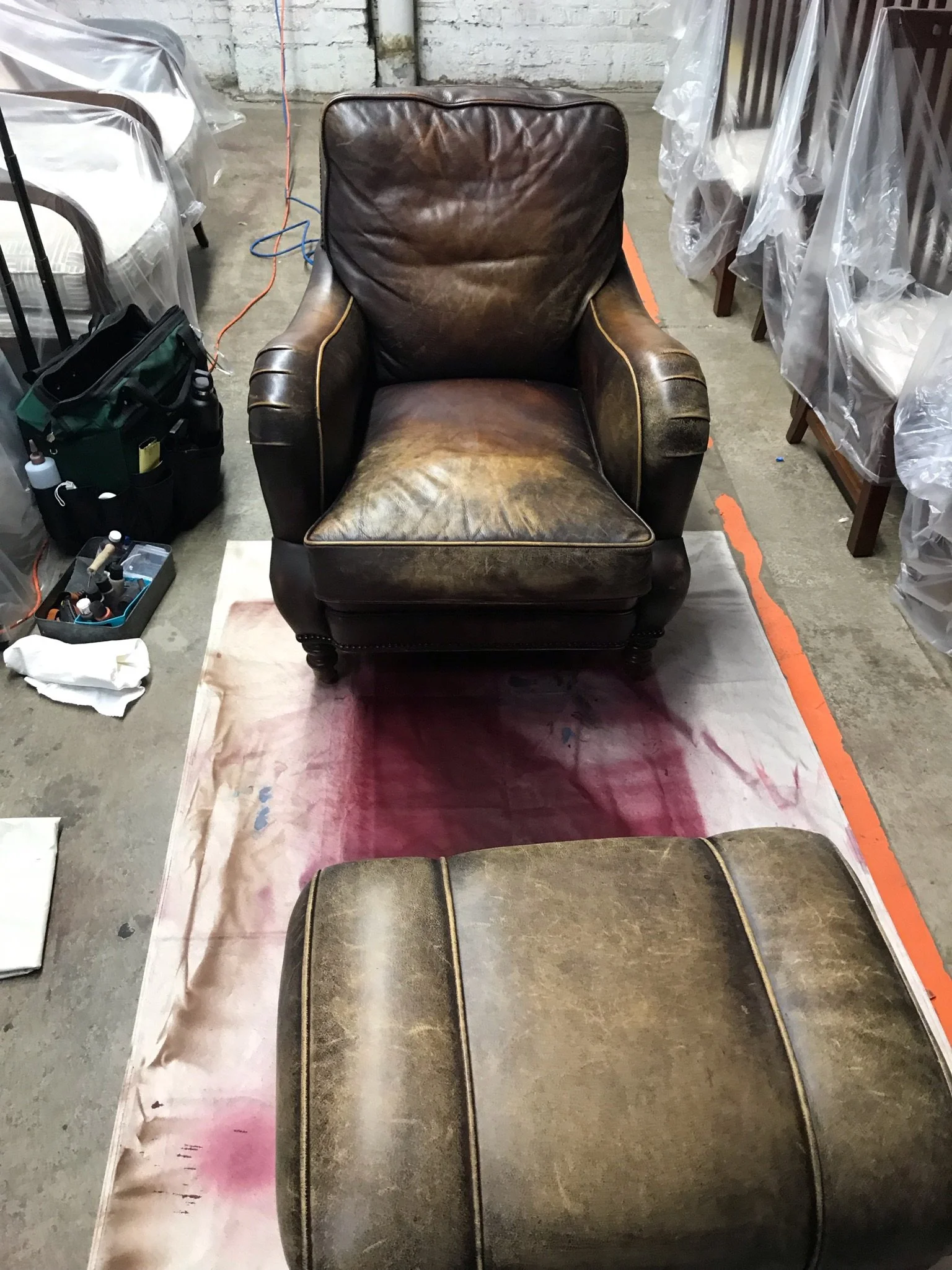 Lounge chair and ottoman with heavy wear from years of use. Cutomer located in Ravenswood, Chicago, IL