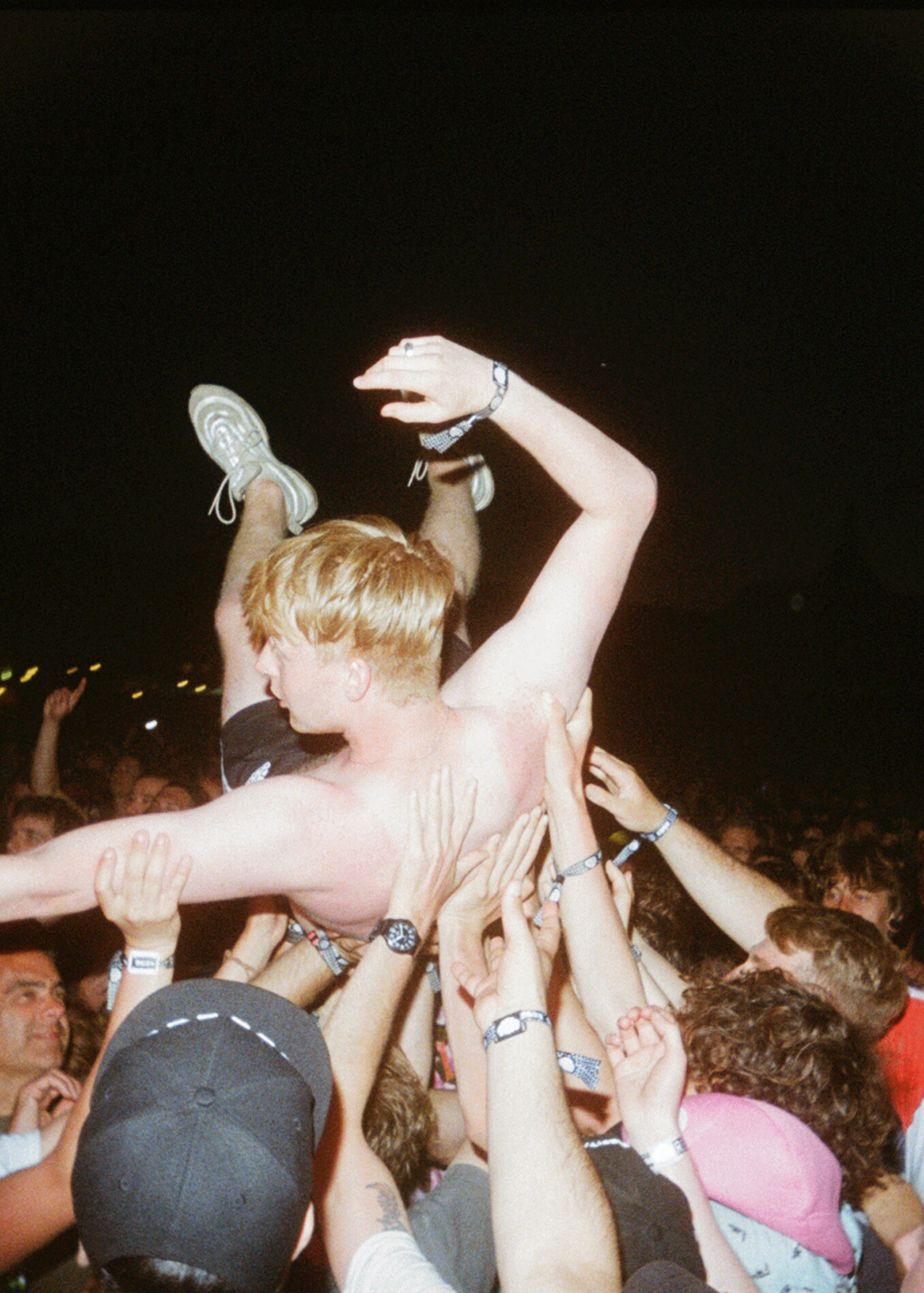 man-crowd-surfing-topless.gif
