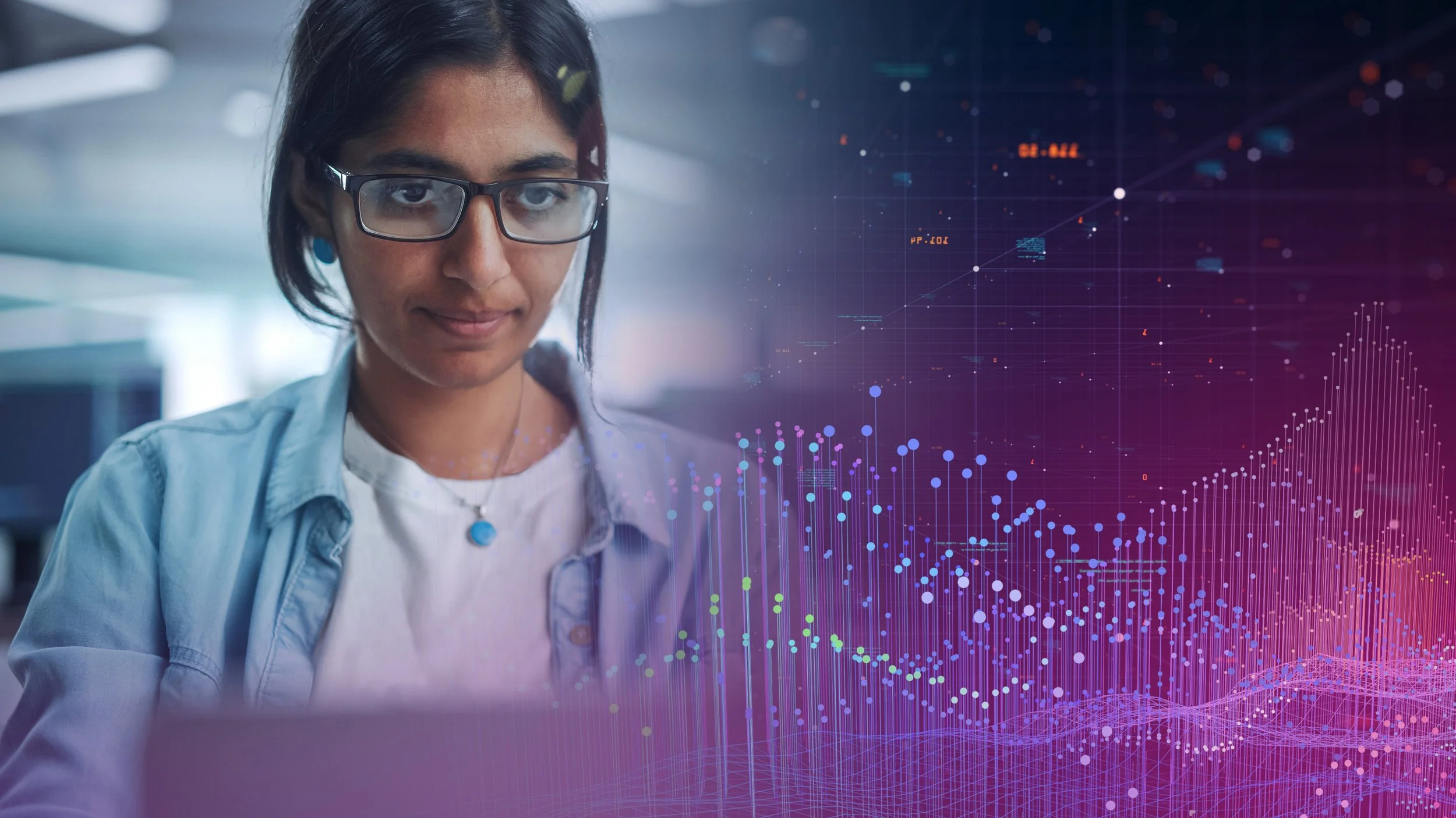 A young woman with glasses looking at a laptop in a modern office, with digital data visualizations overlayed on the right side of the image.
