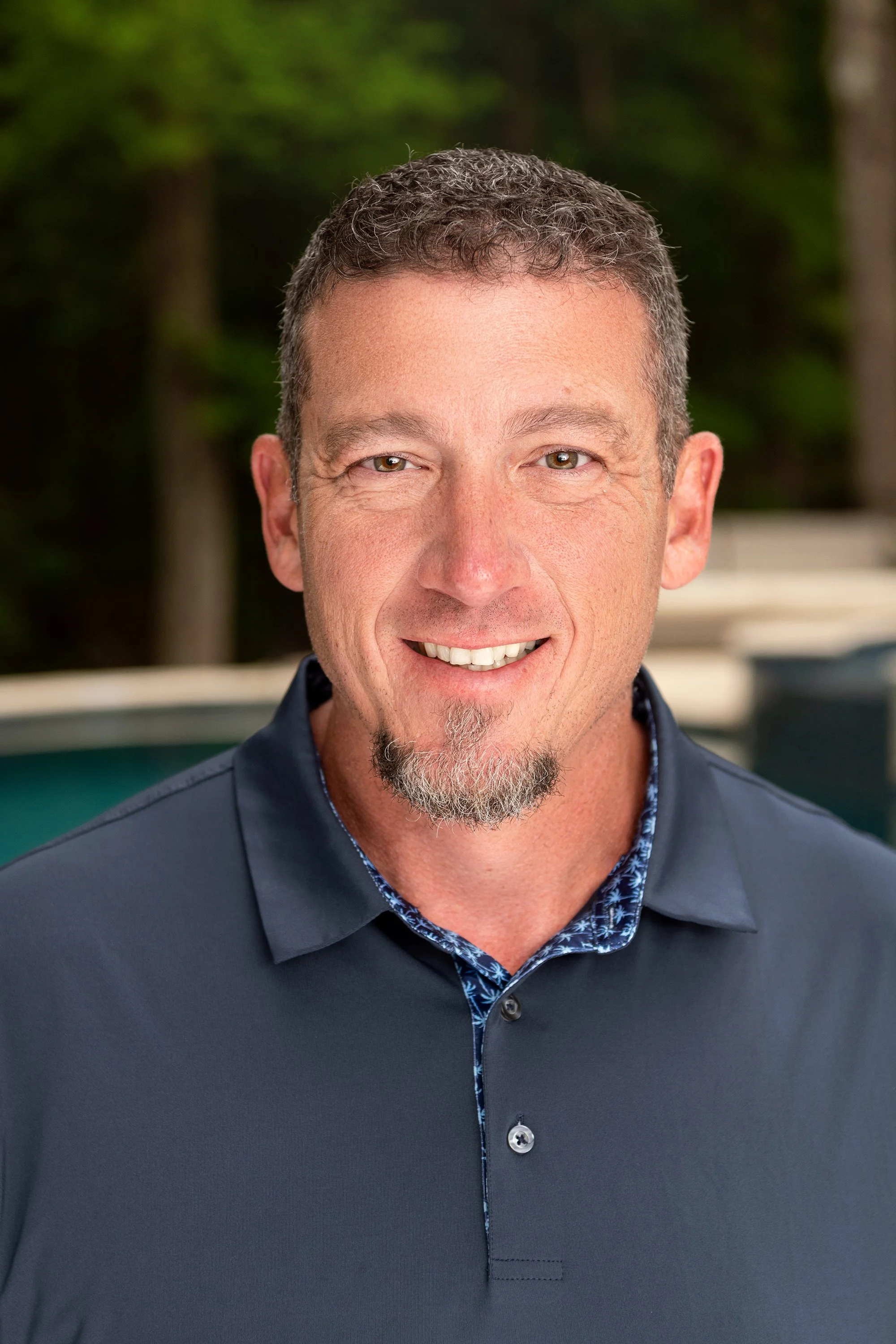 Professional branding headshot of Scott Rutherford, owner of RutherfordMade Pools, photographed outdoors in natural light in Atlanta, Georgia, showcasing a confident executive portrait for luxury pool design and outdoor living branding.