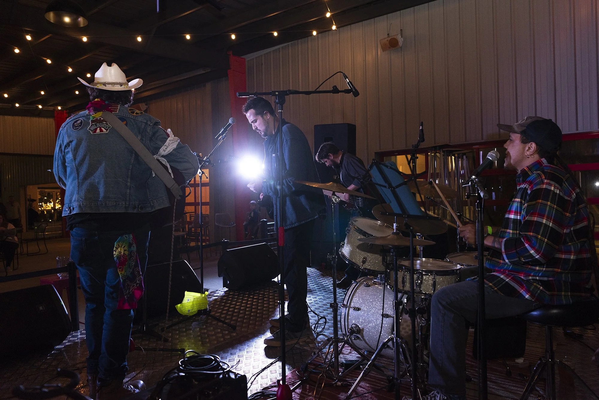 Atlanta live music and event photography by Caitlin Tabilog featuring band performance at Reformation Brewery Roswell GA, emotional candid concert images with musicians playing guitar drums and singing