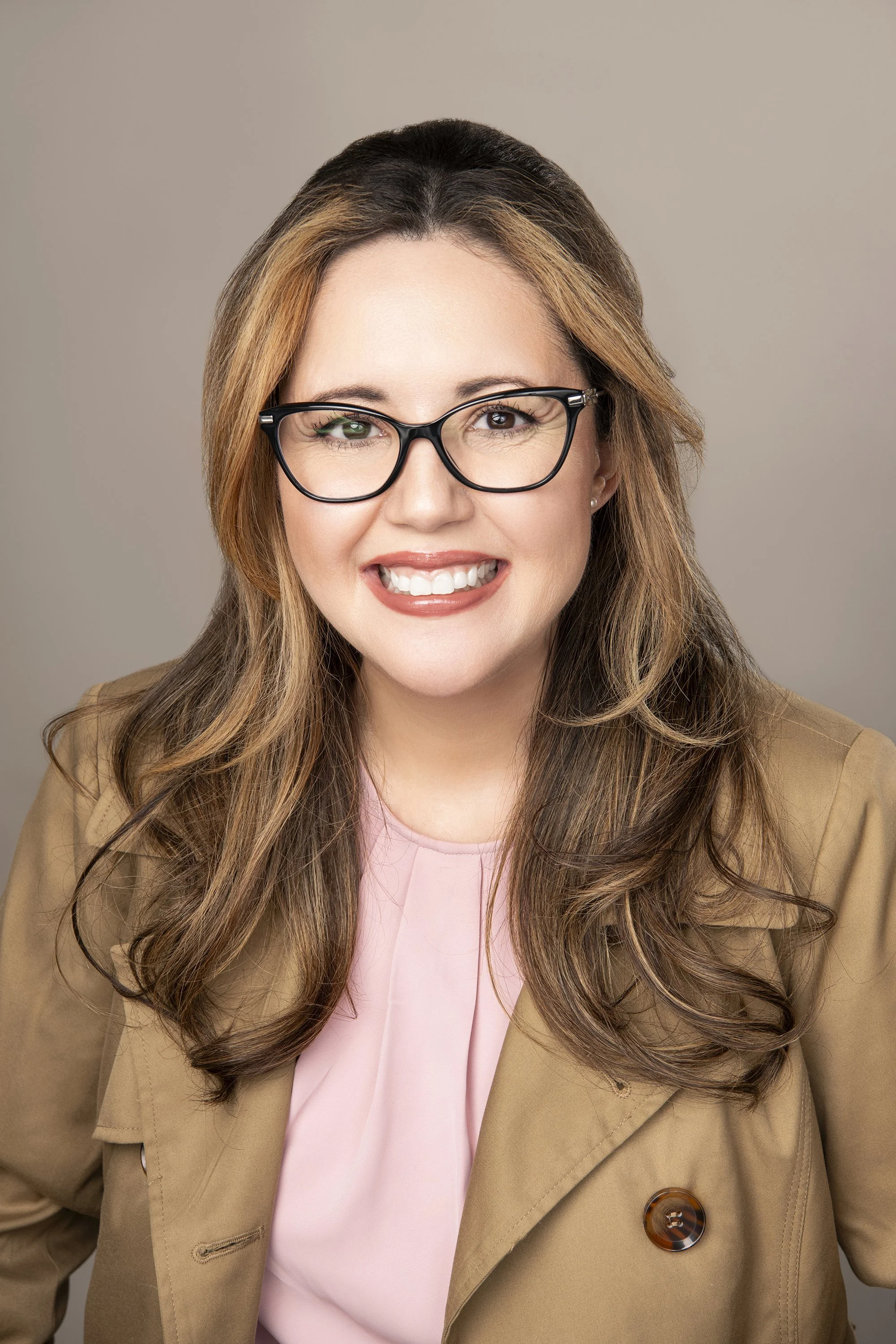 Professional branding headshot of author Anne Prado in a Milton, Georgia studio featuring clean beige backdrop, soft natural lighting, and authentic expression captured by Atlanta portrait photographer Caitlin Tabilog of Atlanta Portrait Co.