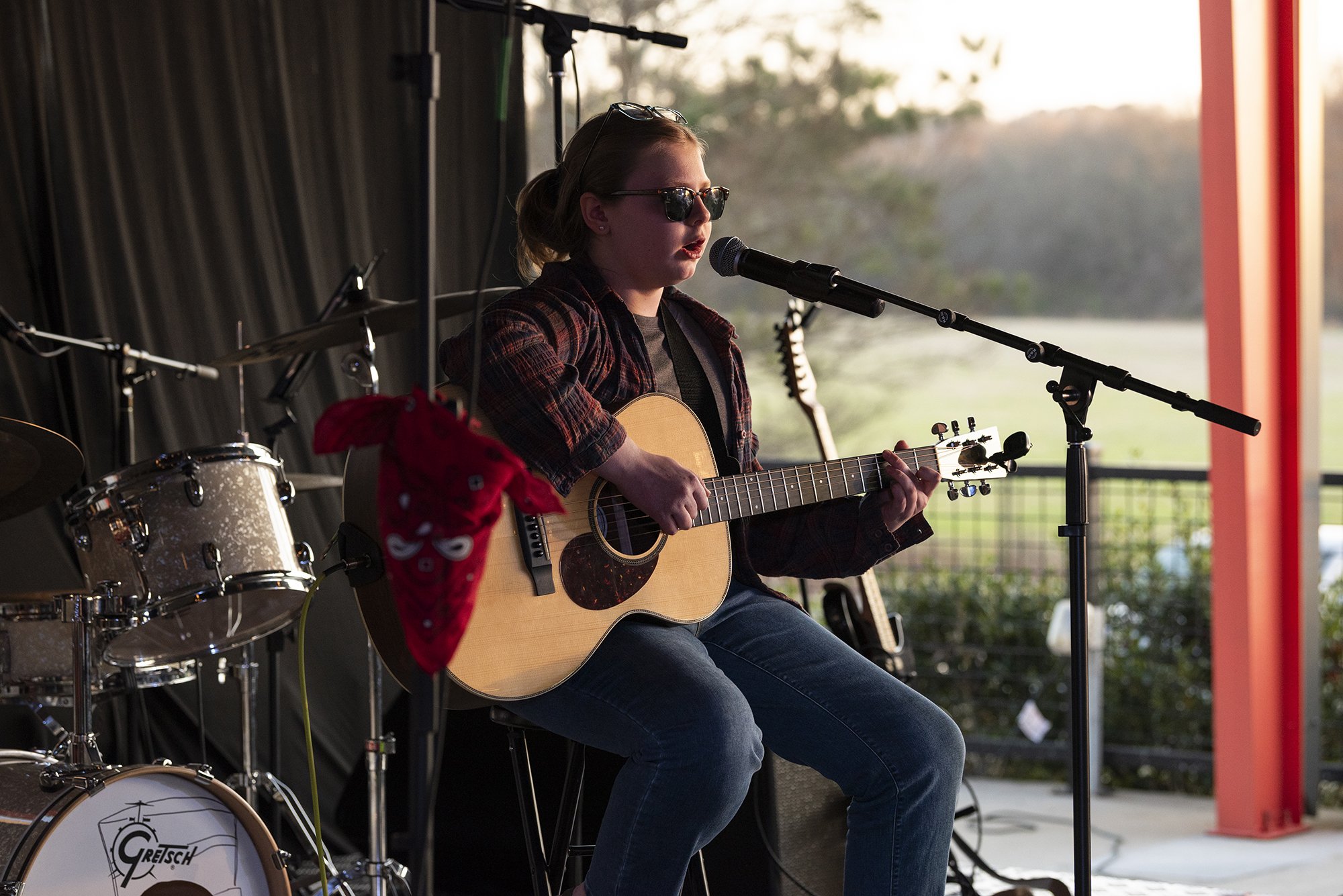Atlanta event photographer Caitlin Tabilog capturing live band performance at Reformation Brewery in Woodstock GA, candid emotional concert photography with guitar drums and singer performing together
