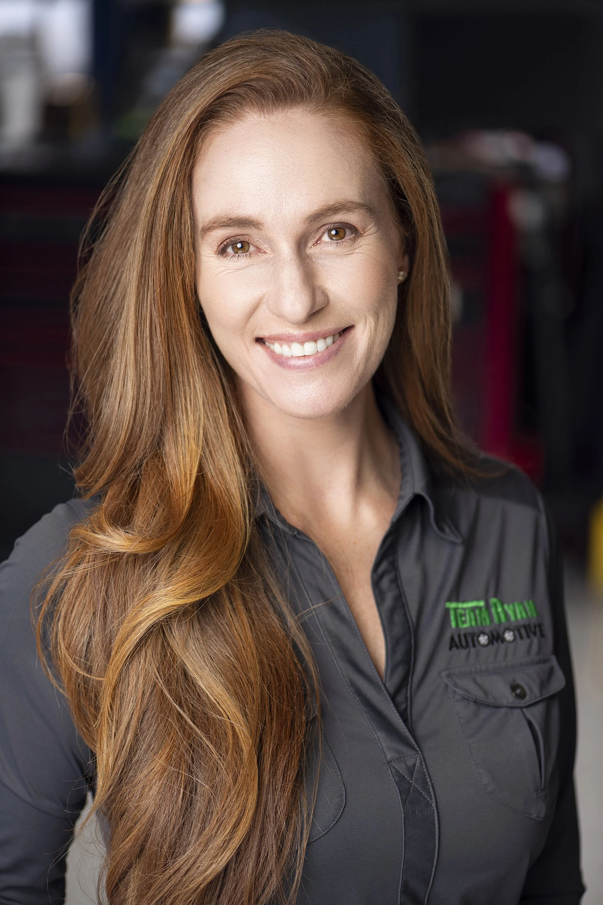 Professional corporate team headshot photographed at Team Ryan Automotive in Buford, Georgia by Atlanta portrait photographer Caitlin Tabilog using studio lighting.