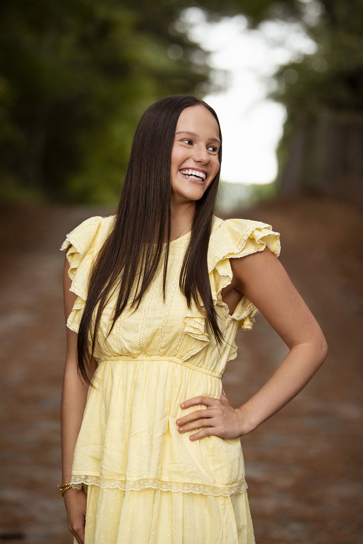 High school senior portrait session with natural light at a scenic location in Milton, GA.