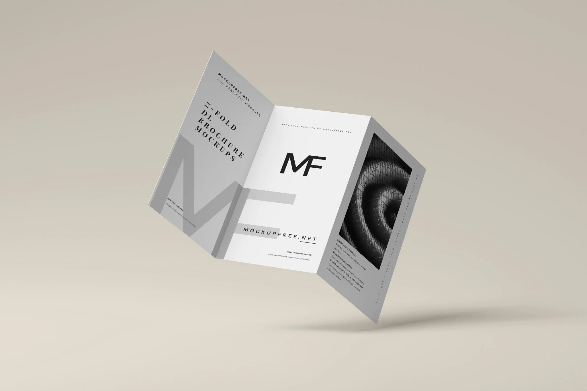 A tri-fold brochure mockup featuring black and white graphics and text, including the letters 'MF' and a coiled black hose or cable image.