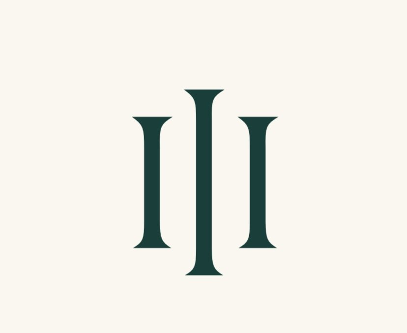 A logo with a stylized, symmetrical design consisting of three vertical, elongated elements on a light background.