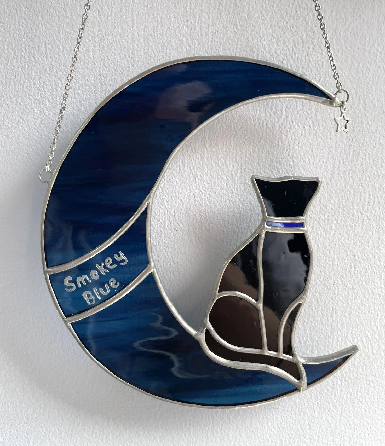 Stained glass commission by Crafted Colours of a black cat sitting in a crescent moon
