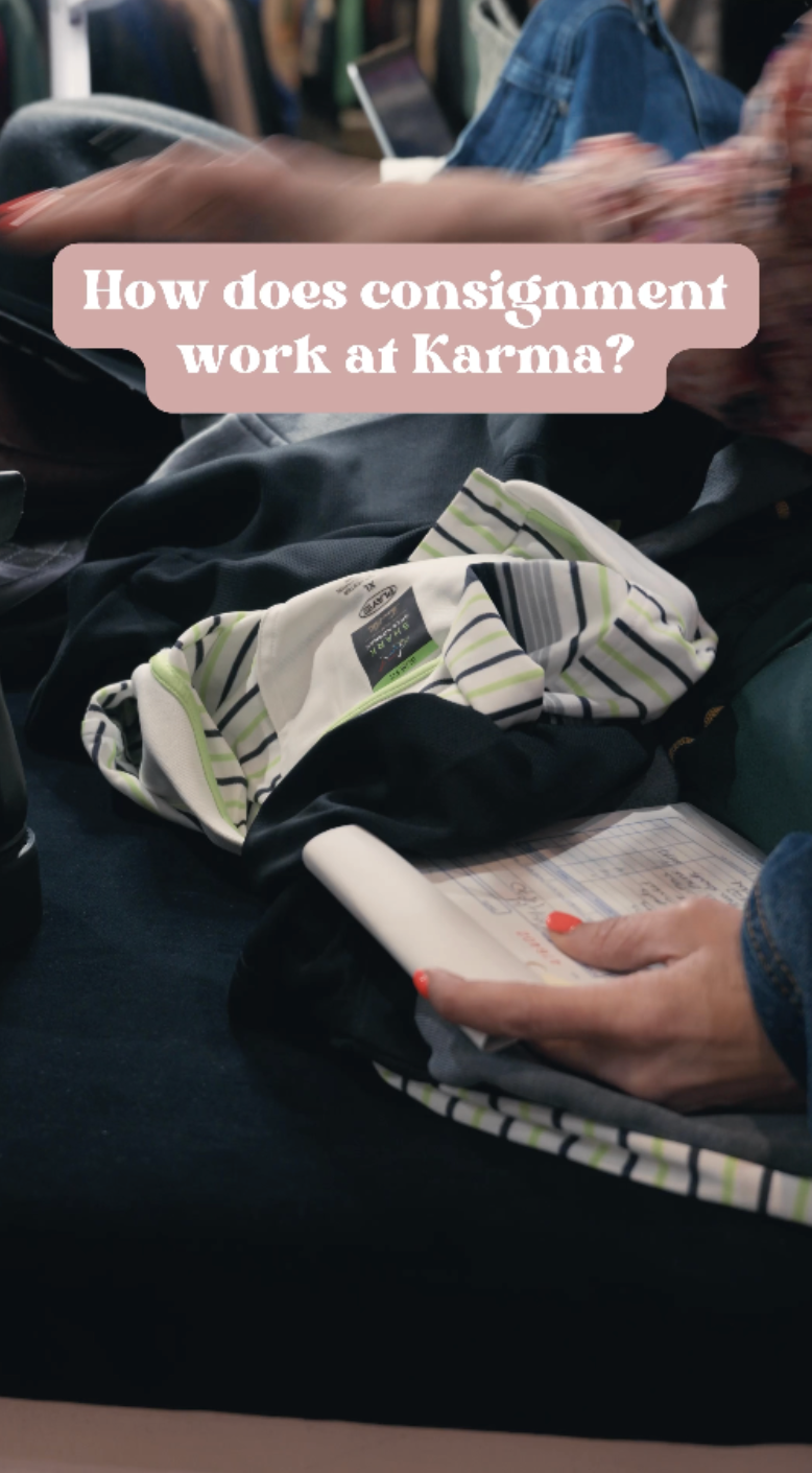 A person with bright red nail polish holding a flight attendant boarding pass or ticket, sitting among bags and clothing at what appears to be an airport check-in or boarding area, with a pink overlay text asking about how consignment works at Karma.