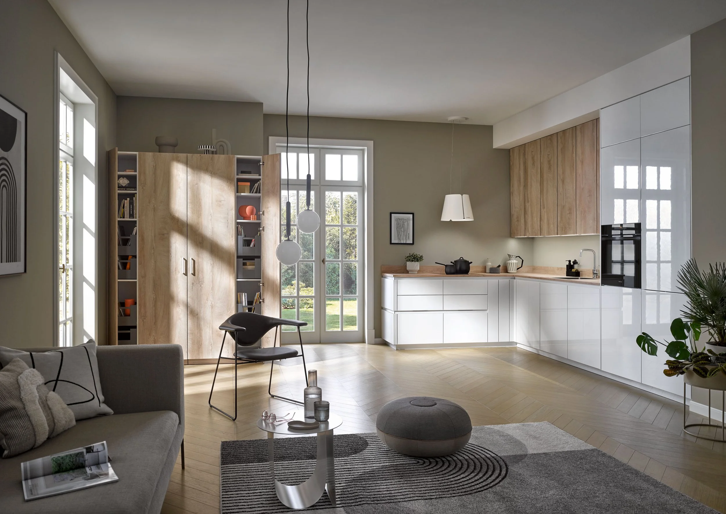 Modern open-concept living room and kitchen with natural light, minimalist furniture, and light wood accents.