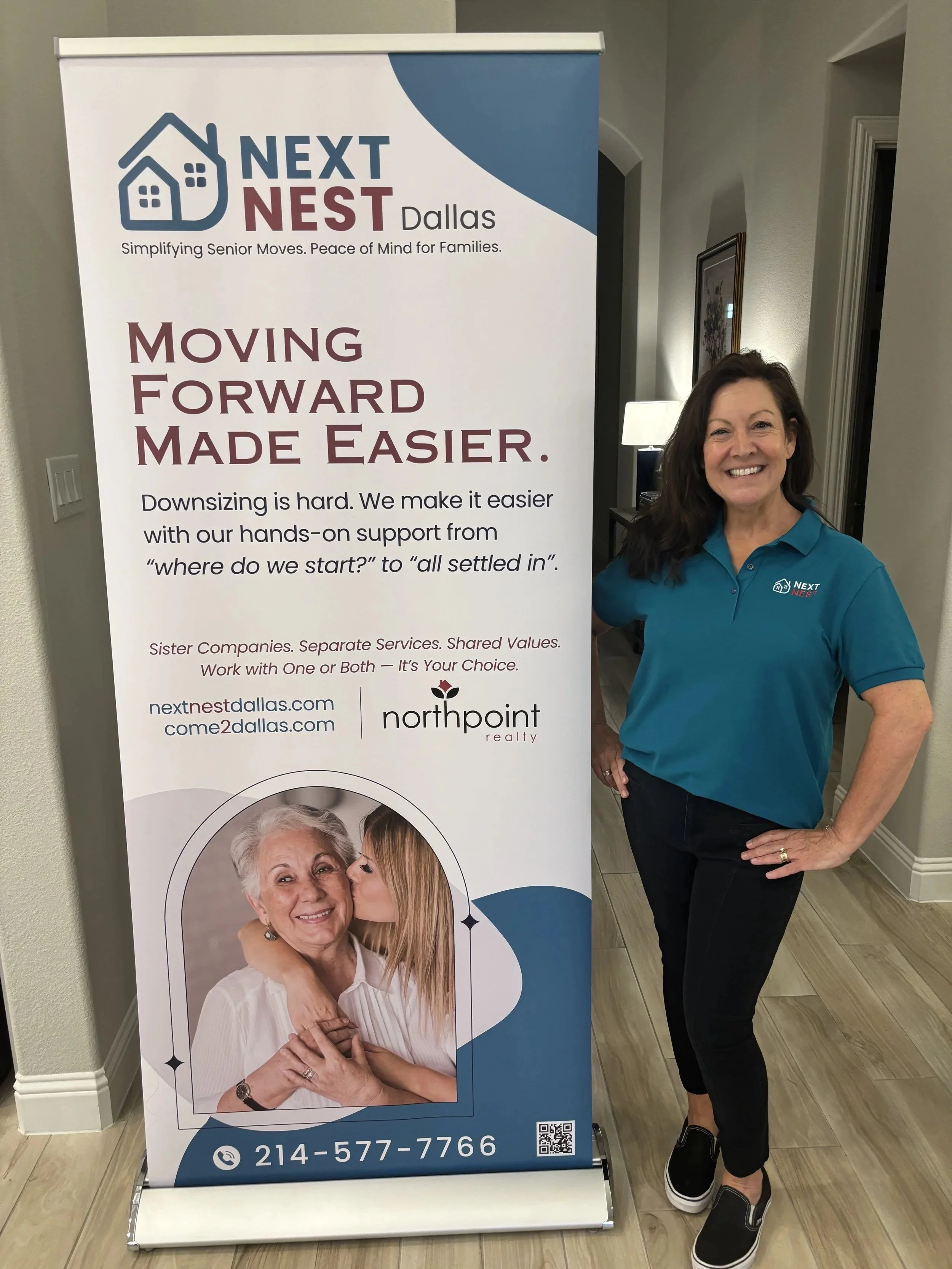 Sharon Sinnes, Move Designer at Next Nest, standing next to an event banner