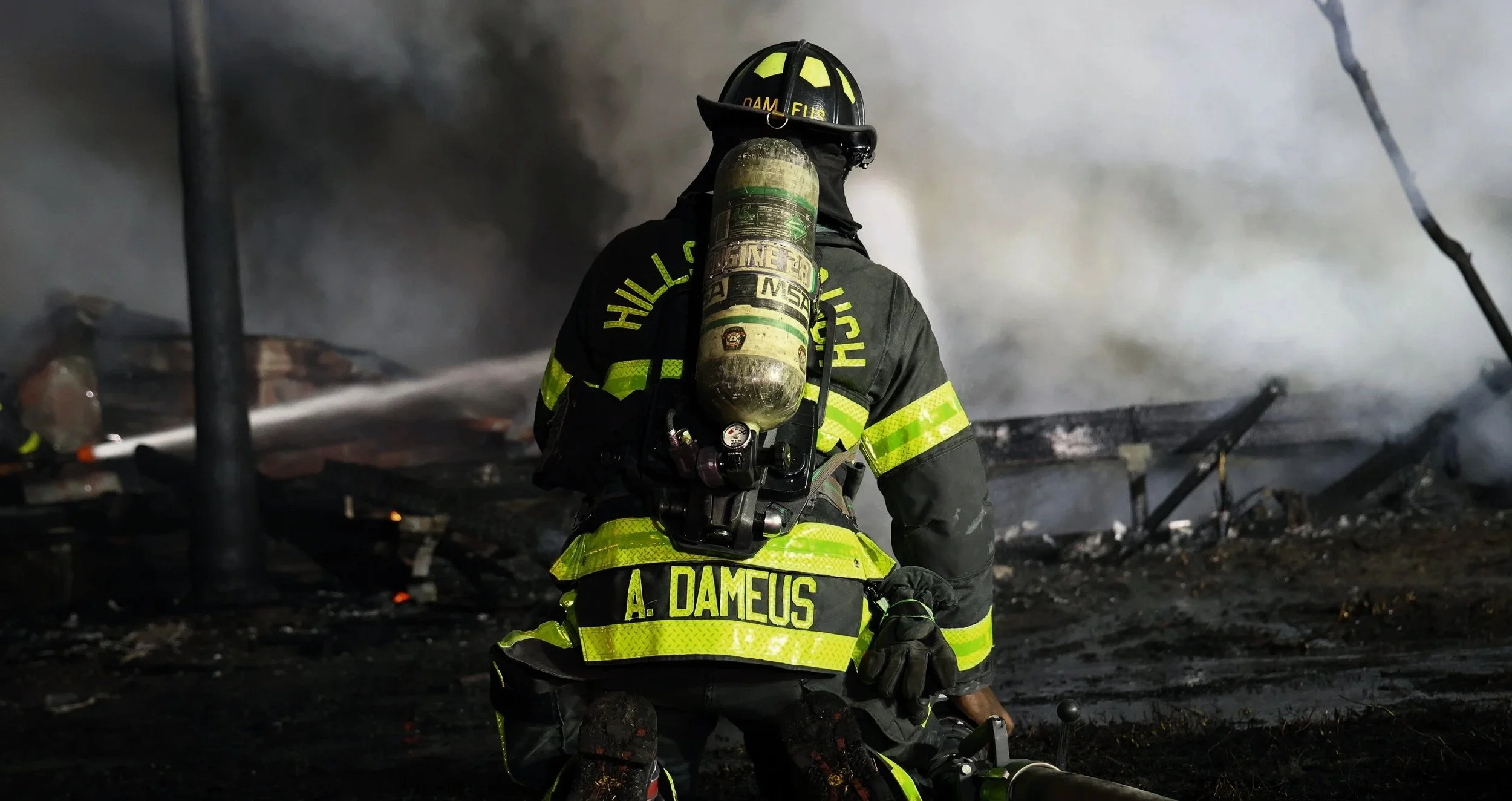 Firefighters obscured behind flames