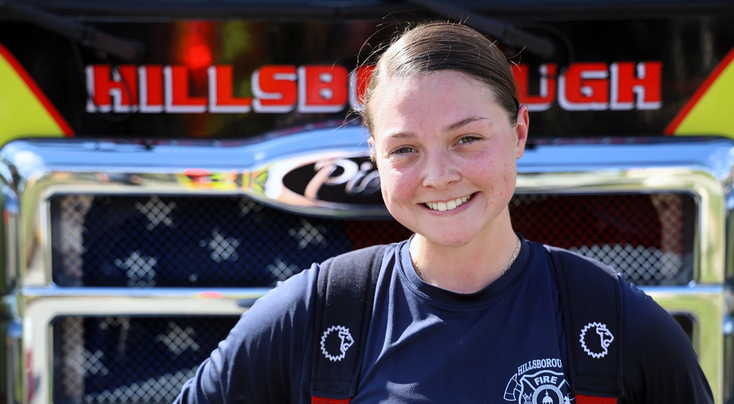 Smiling Firefighter in front of a Hillsborough County Fire Truck