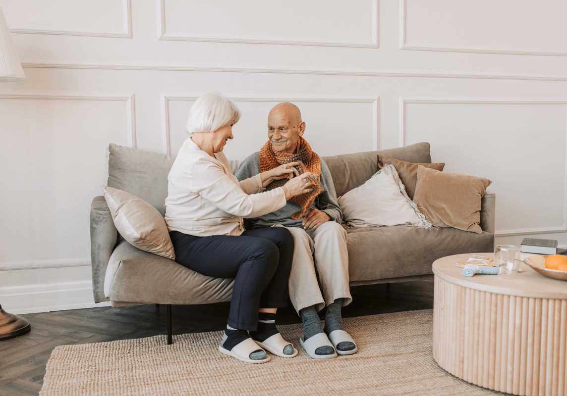 Older adults sitting together at home, representing a comfortable and independent senior living lifestyle