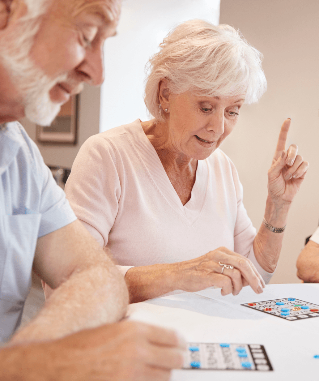 Older adults playing a game together, representing social and active independent living