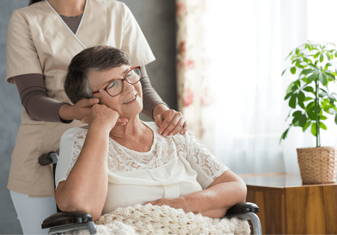 A caregiver gently supporting a senior woman, reflecting compassionate, personalized assisted living care