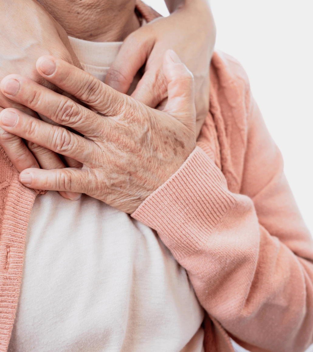 Close-up of a caregiver comforting an elderly person with supportive touch