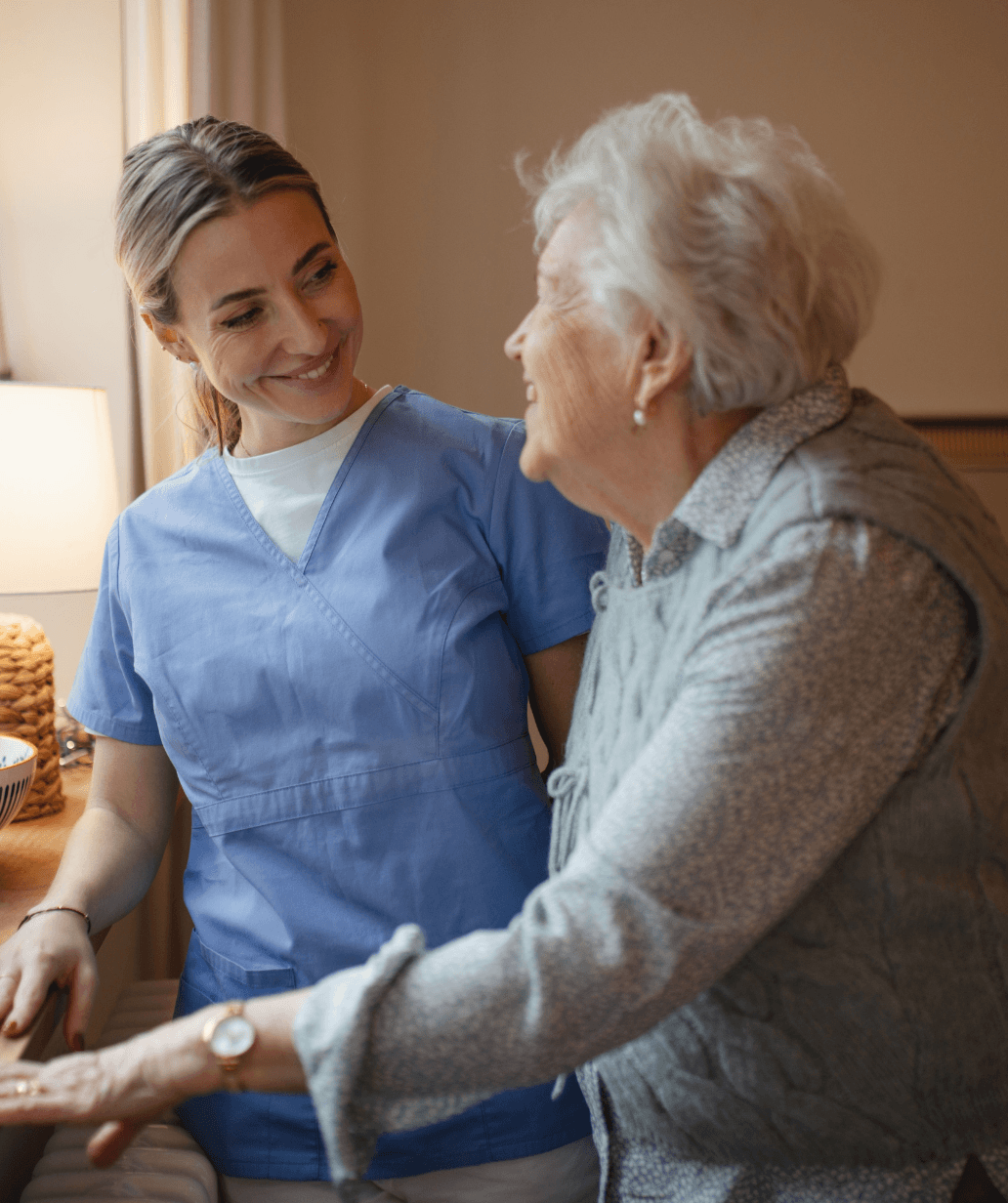A caregiver supporting an older woman, reflecting personalized, compassionate assisted living care