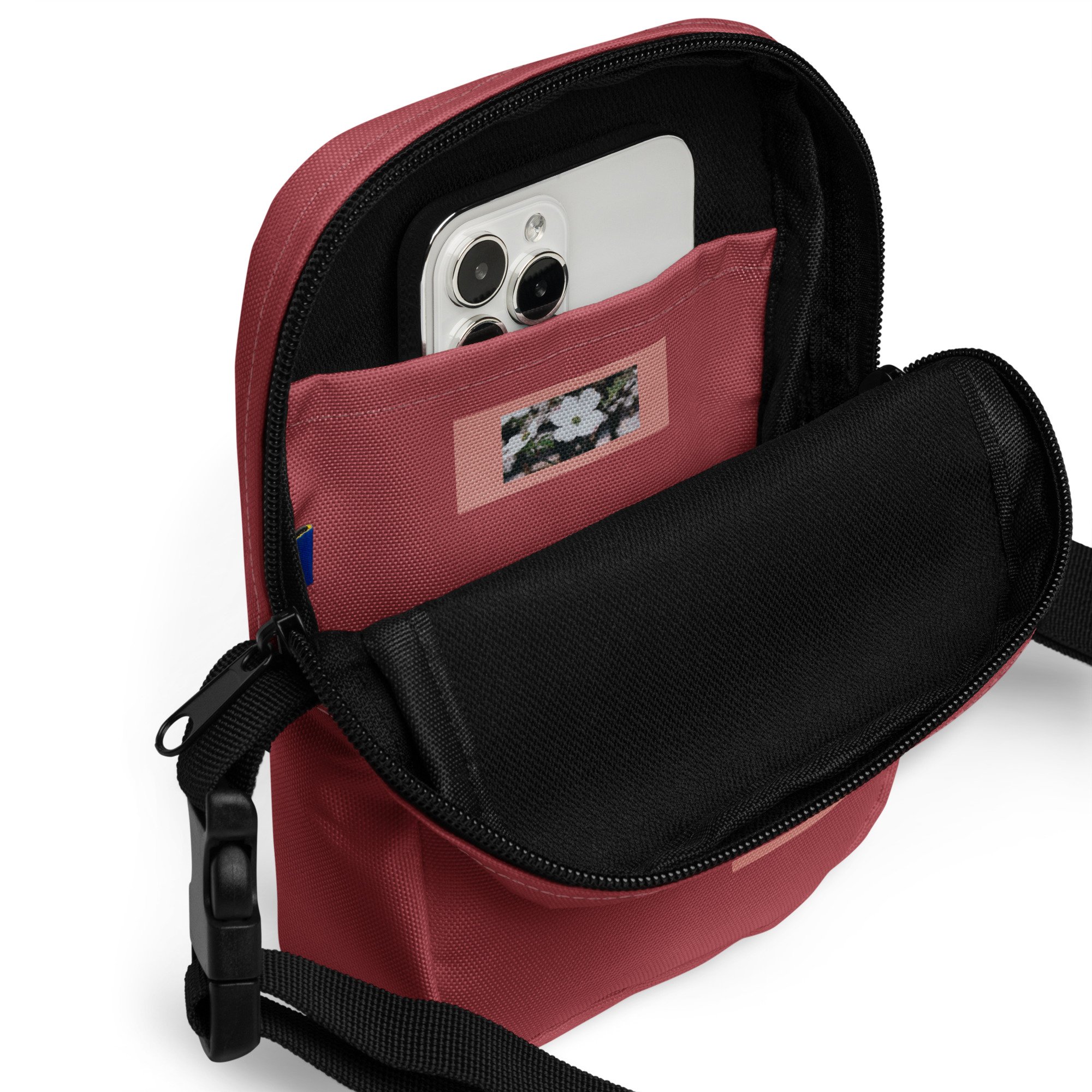 closeup of inside pocket of red utility crossbody bag with photo of dogwood flower printed on the inside pocket