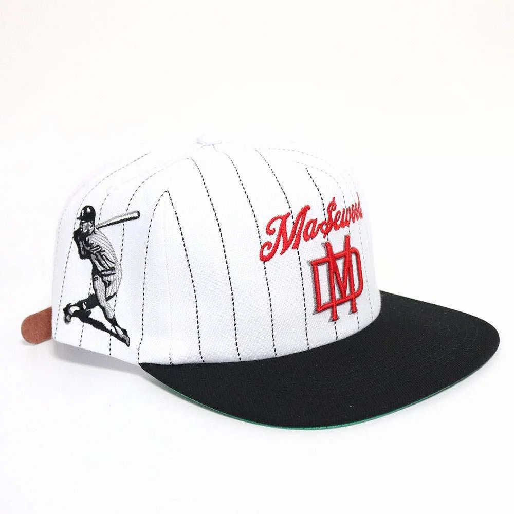 White baseball cap with black pinstripes, featuring a batting player graphic on the side, red "Ma$euw" and logo embroidery on front, and black brim.