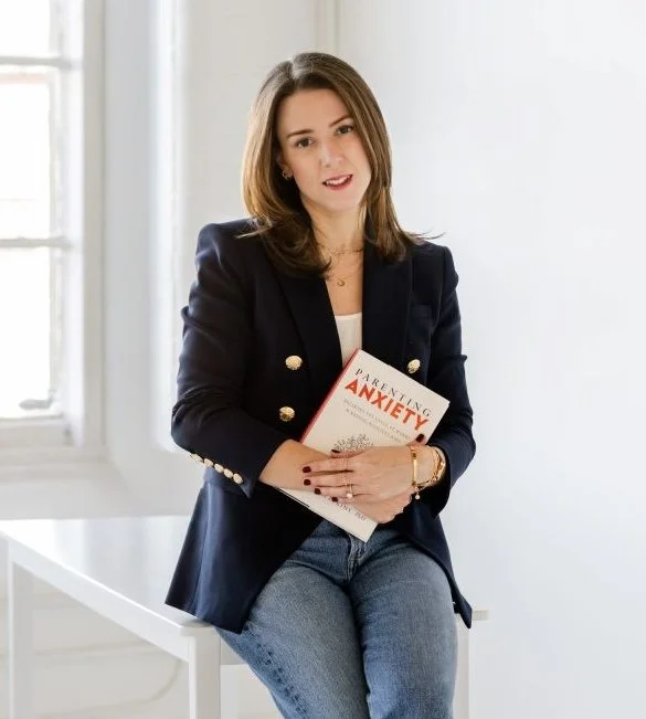 Meredith Elkins, PhD, holds a copy of her book Parenting Anxiety.