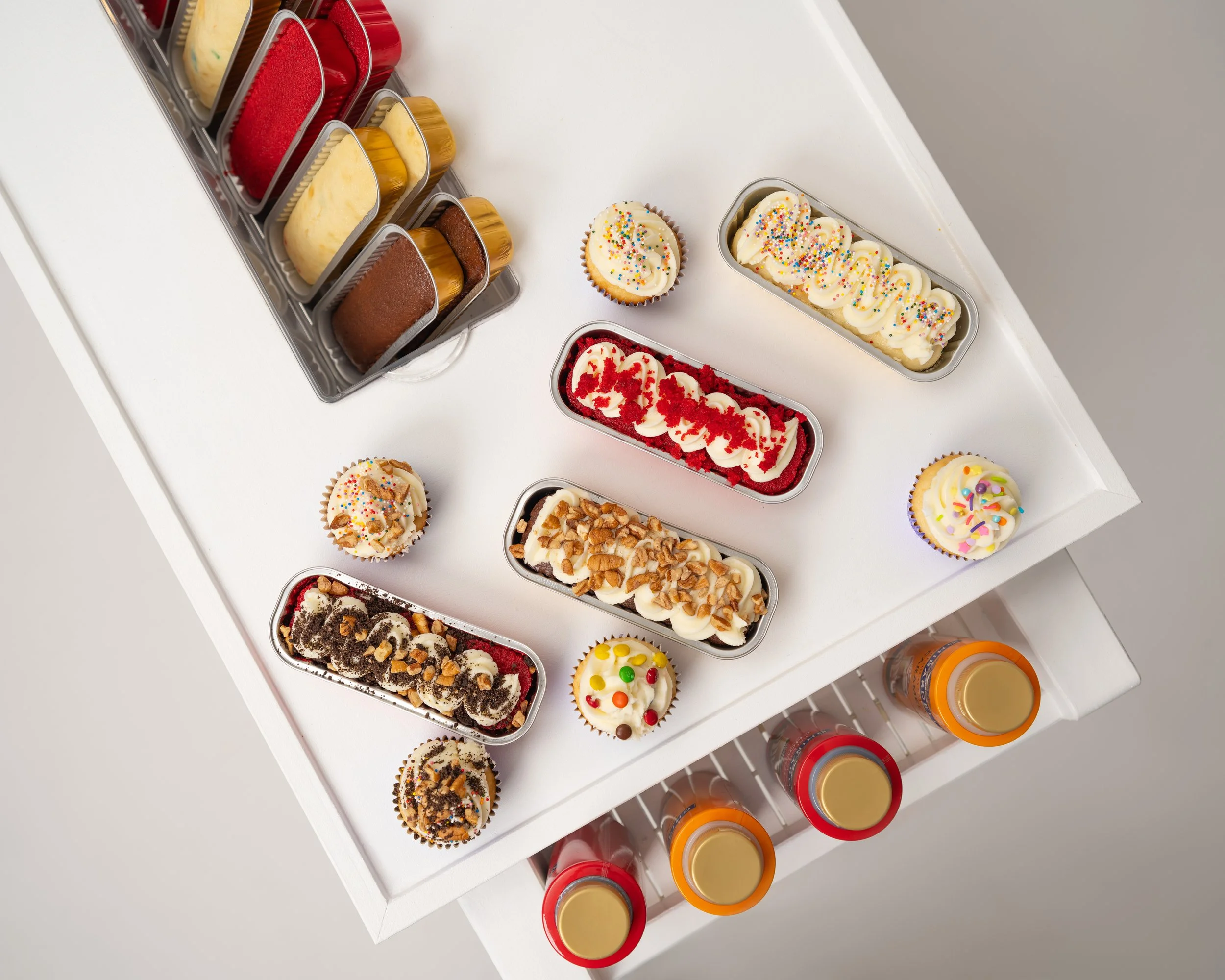 cake bar with multiple cake and cupcake flavors and toppings