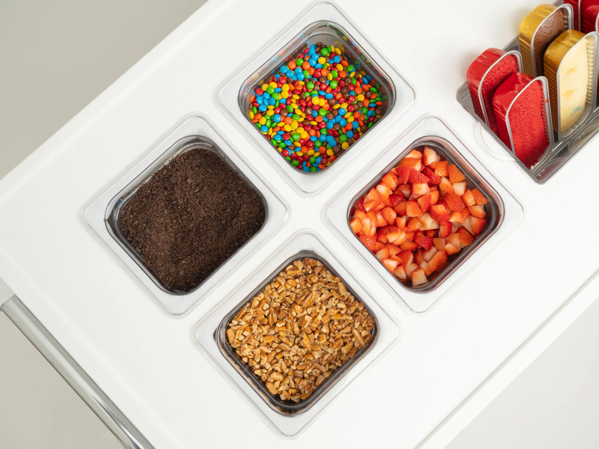 cake toppings, oreos, pecans, strawberries and M&Ms