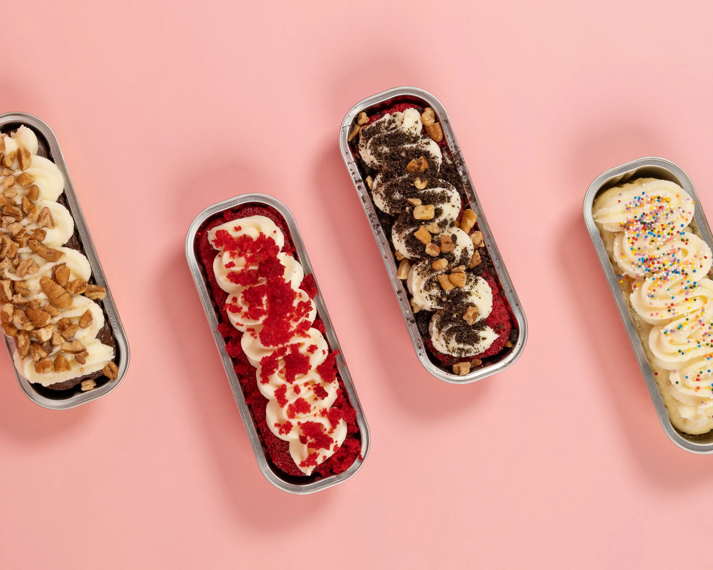 chocolate, red velvet, and vanilla cake loafs with multiple toppings