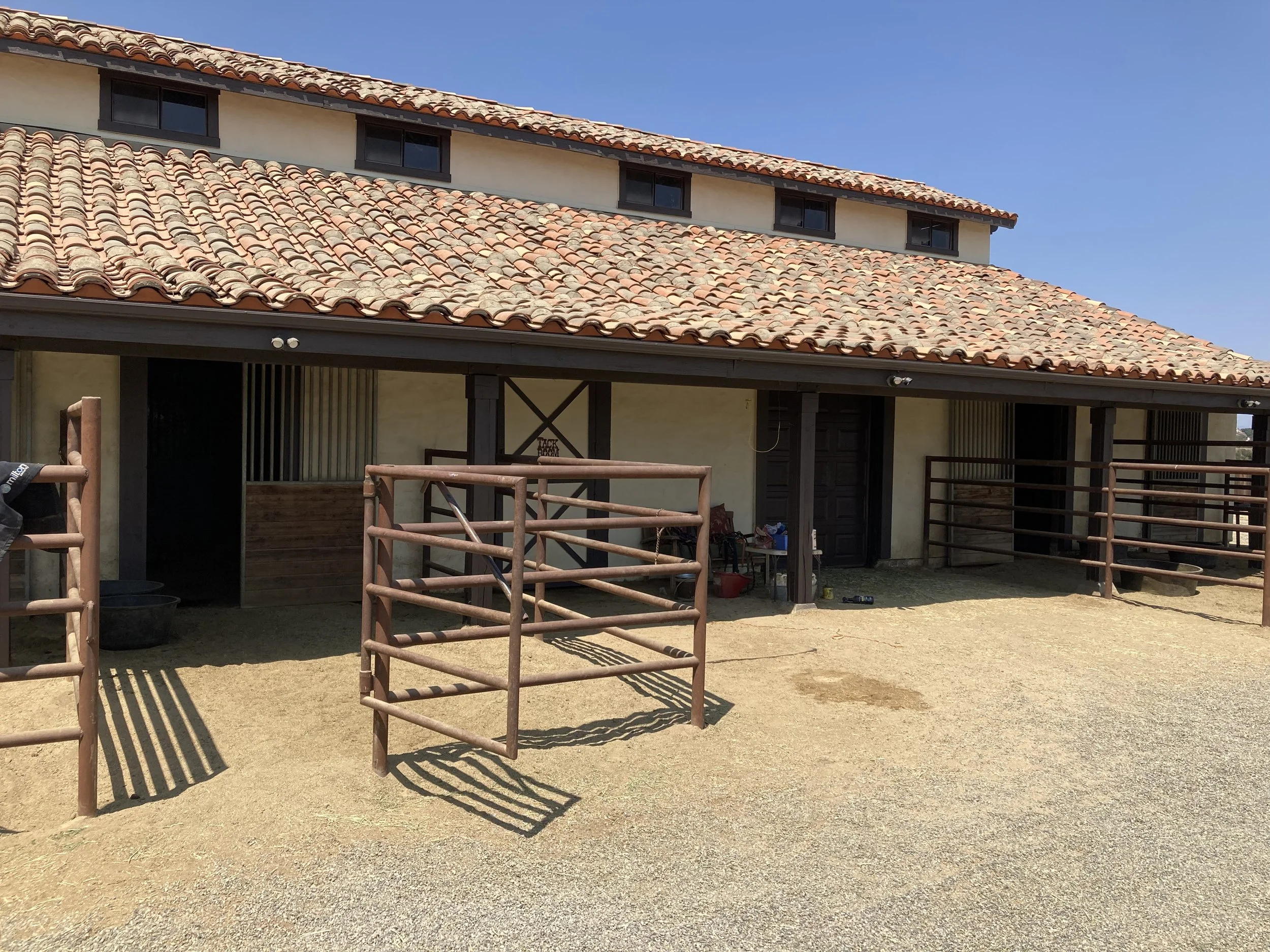 Spanish style horse stables painted by Garrett Dalton Inc