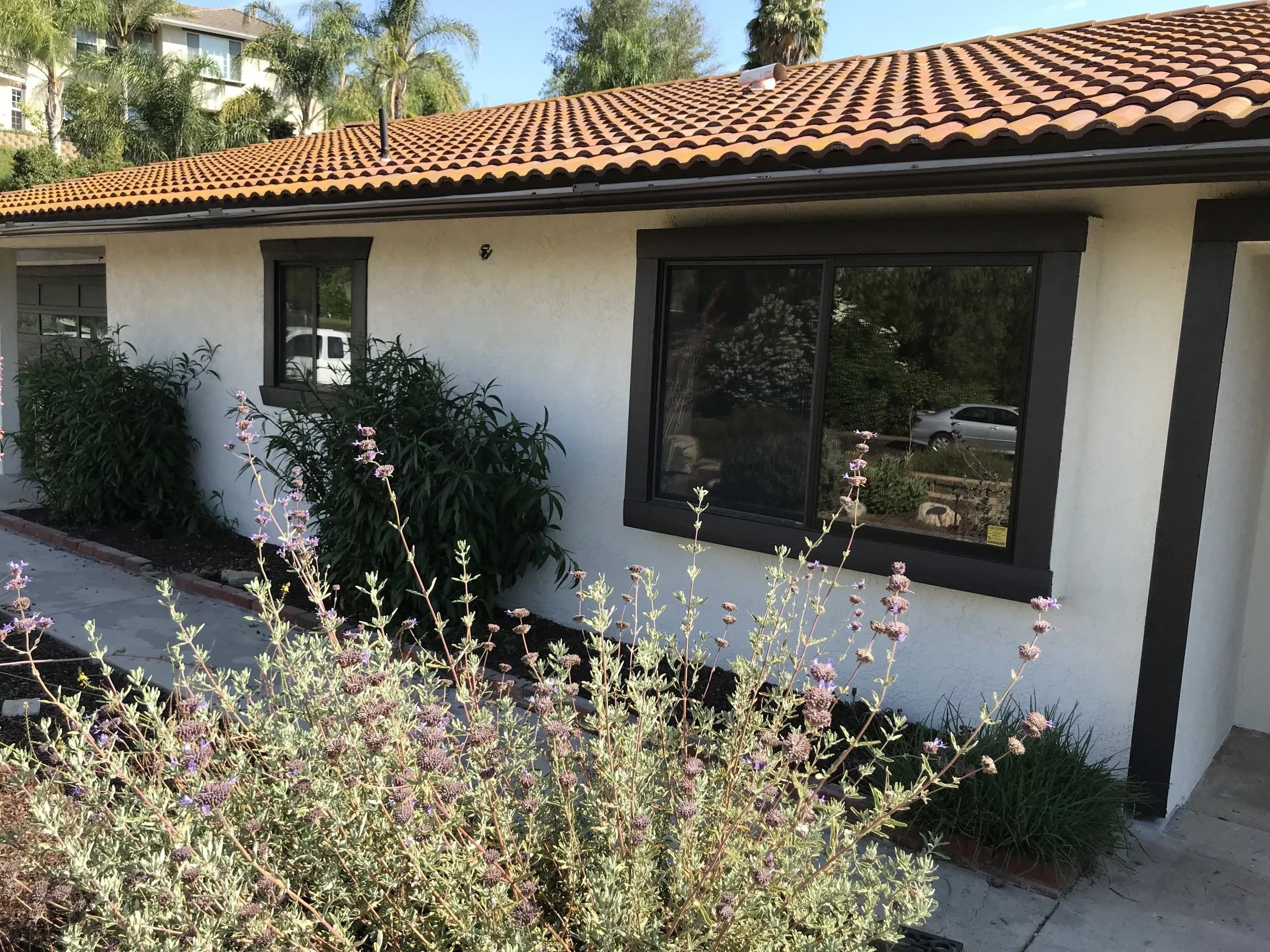 Spanish style home with red tile roof painted by Garrett Dalton Inc