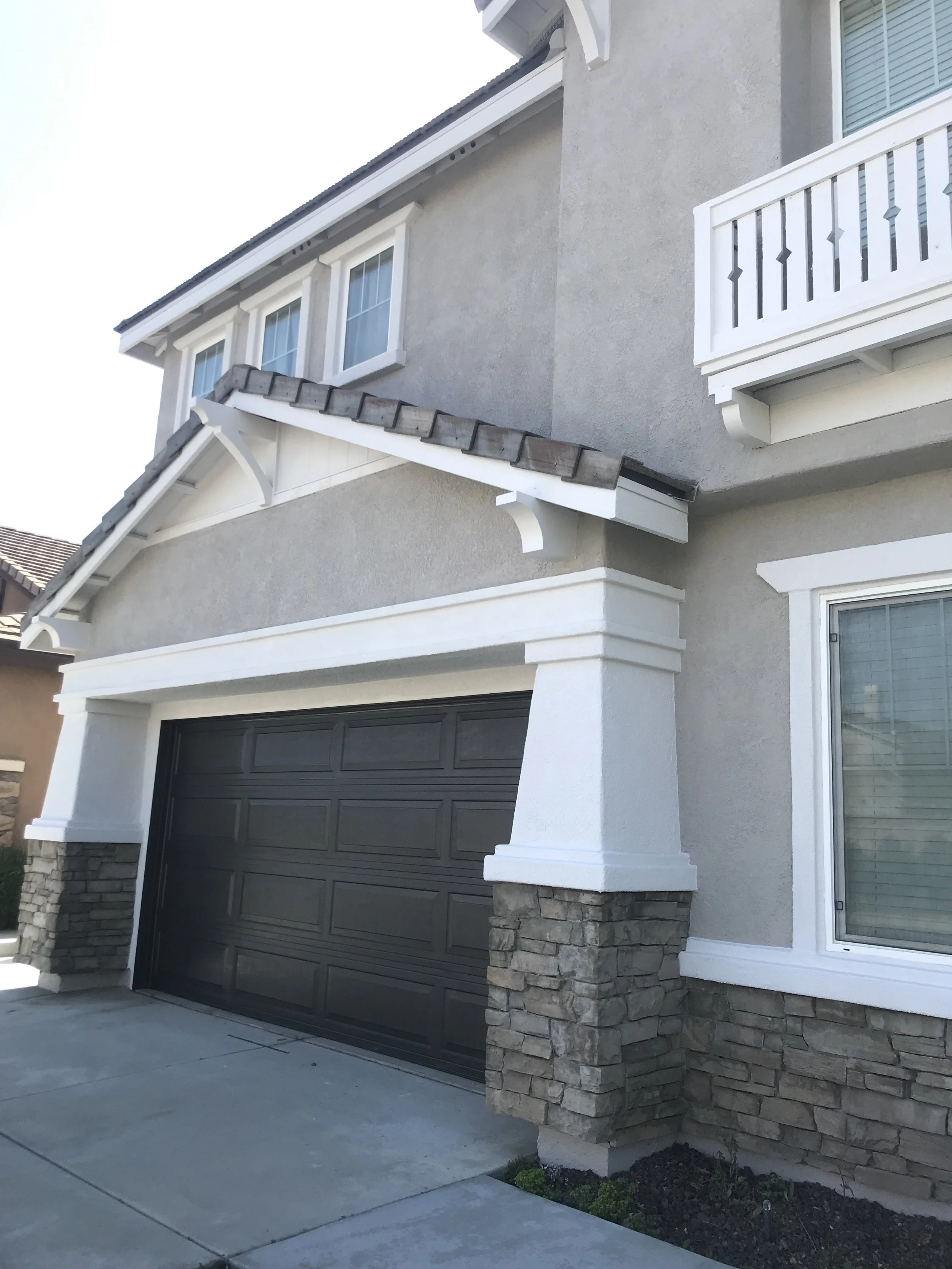 Neutral gray beige color scheme exterior matching stonework, painted by Garrett Dalton Inc