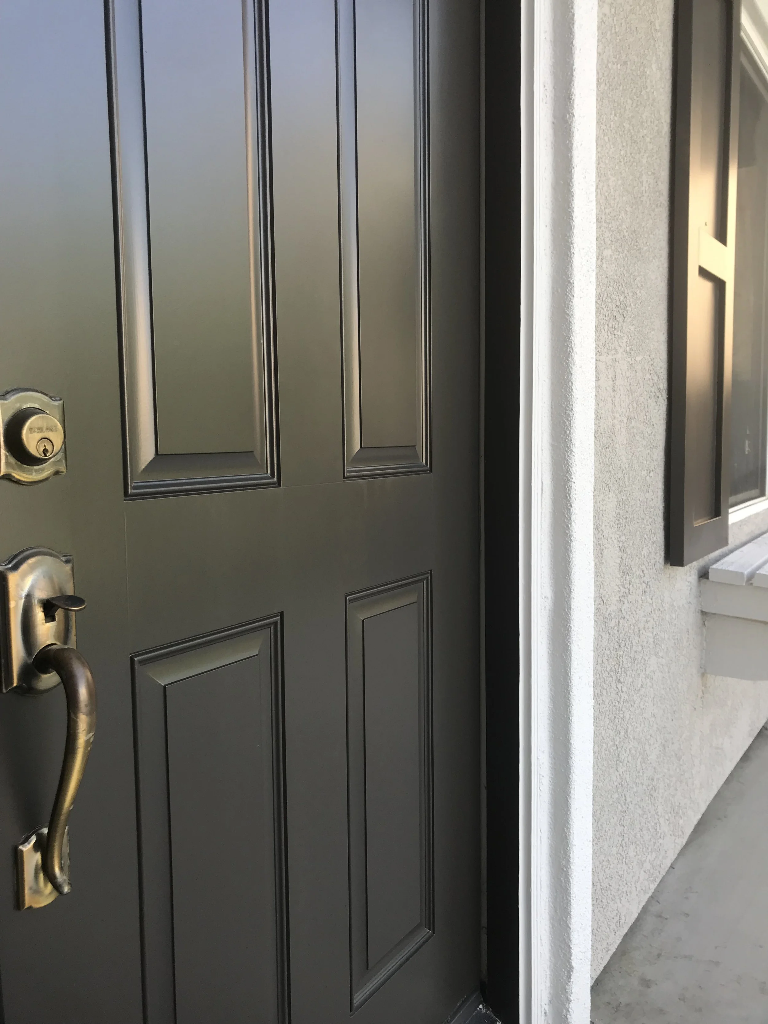 Close up on smooth finish on dark doors painted by Garrett Dalton Inc