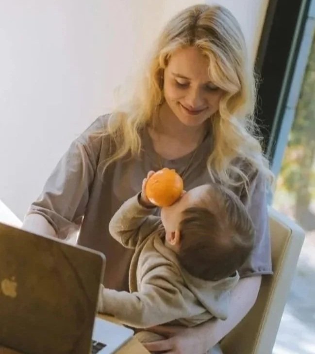 Mother holding her baby close, showing warmth, care, and connection.