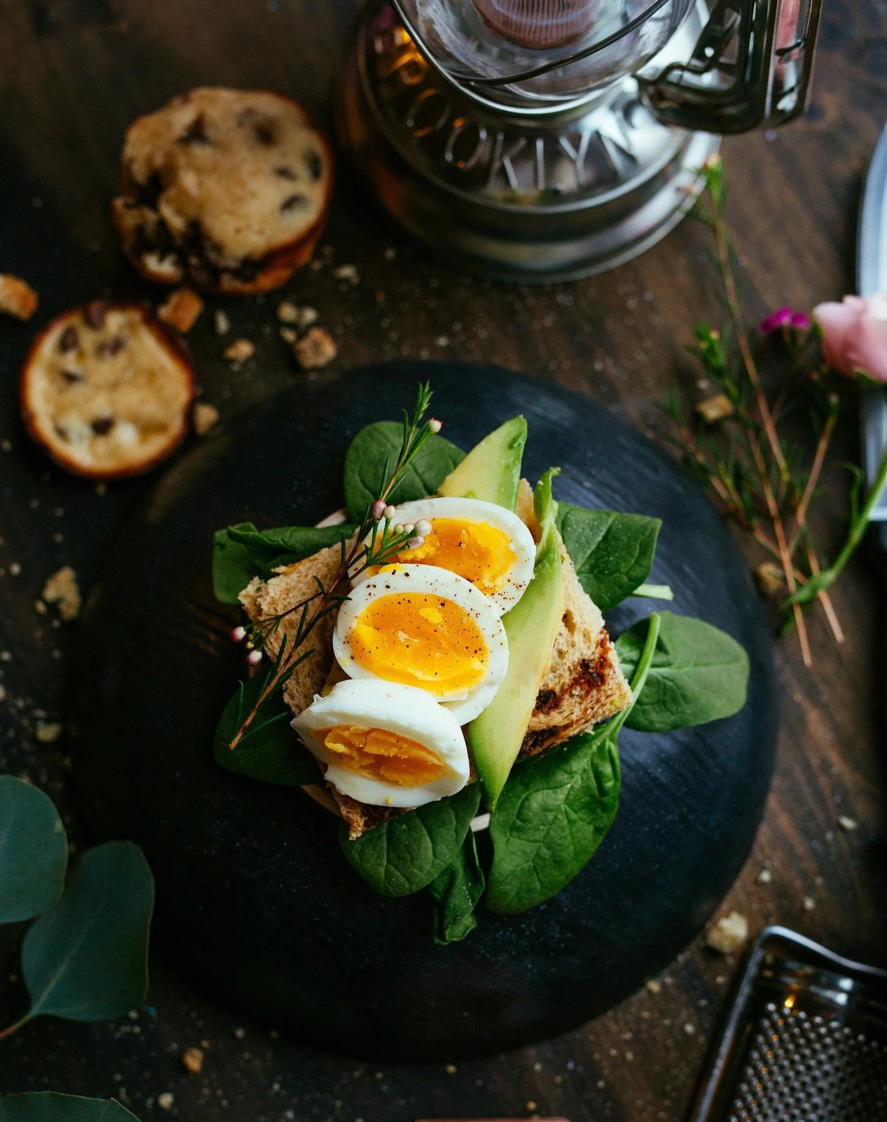Soft-boiled eggs with avocado and sourdough on a plate, representing nutrient-dense real food for pregnancy and motherhood.