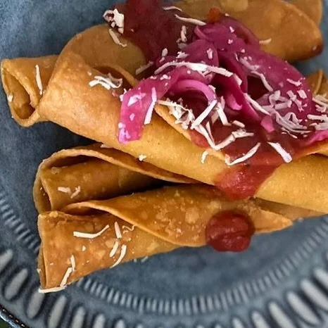 Here for the crunch!  Flautas, fried rolled corn tortillas packed with pulled chicken, served with salsa madre, pickled onion + fresh queso fresco fresco.