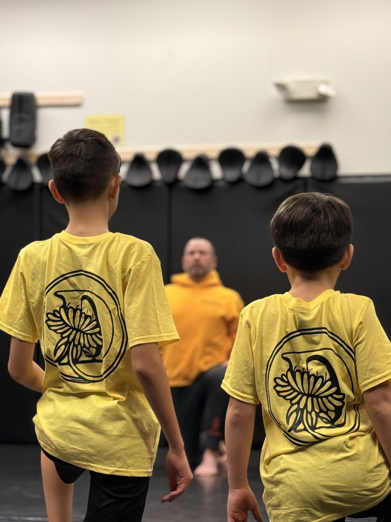 Kids in yellow shirts at a Brazilian Jiu Jitsu class in West Haven, CT