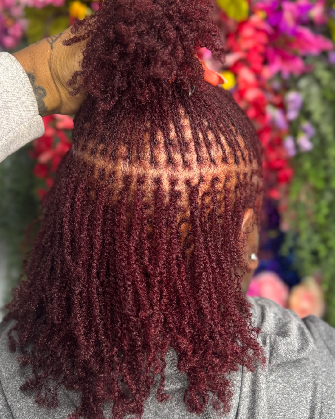 microlocs retightening results with neat roots and defined parts on color treated natural hair