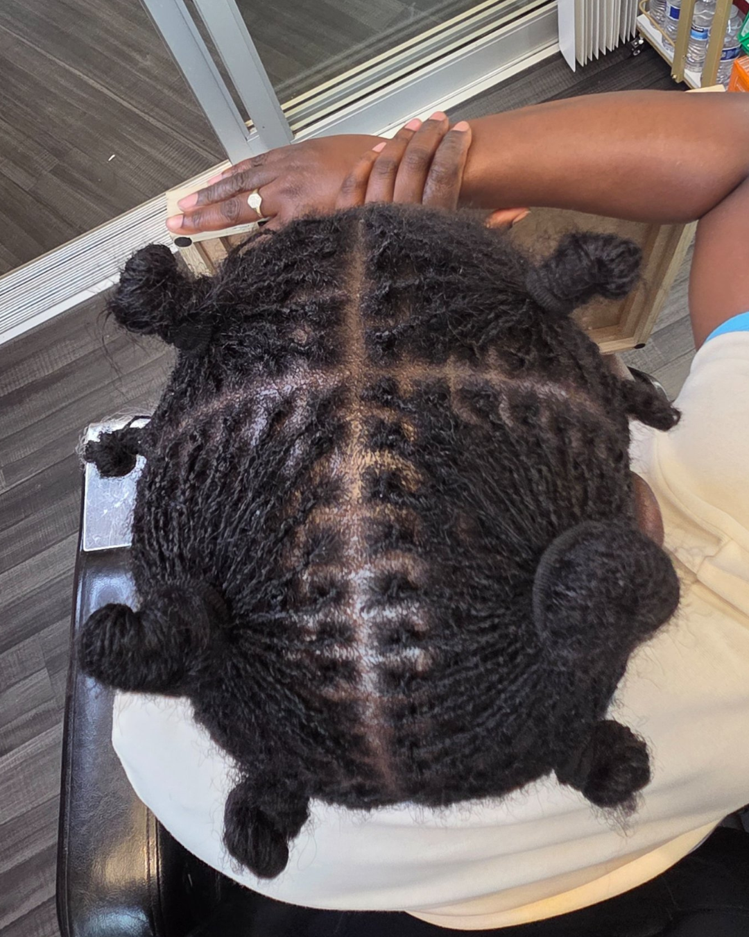 fresh microlocs installation on natural hair by Shamate Reid Brown in Oakland, California