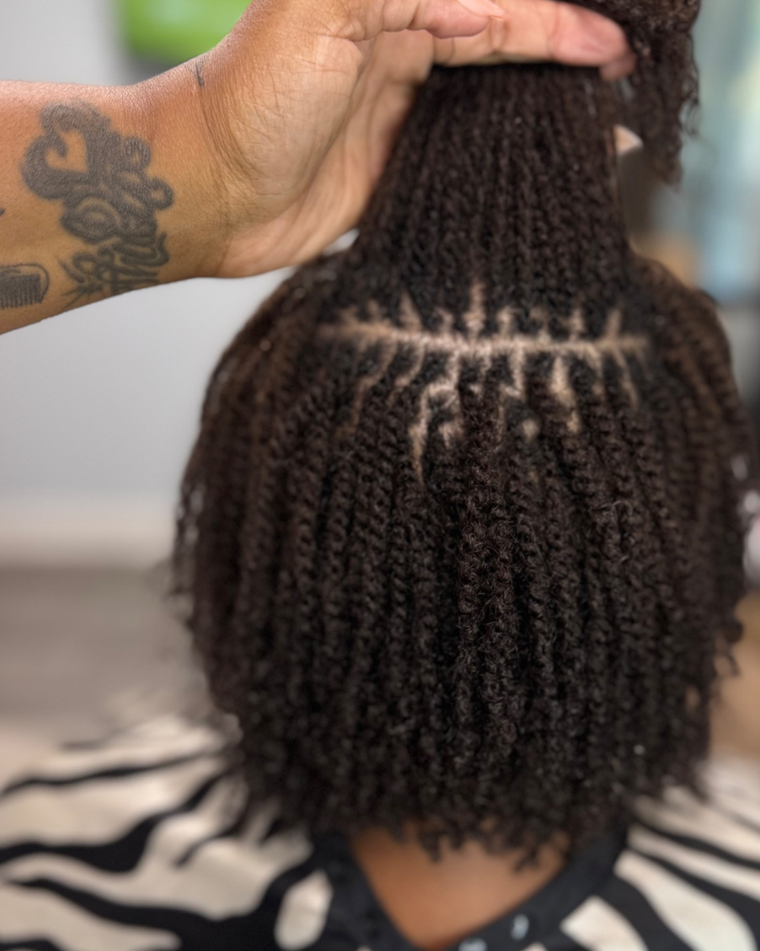 Close-up of small two-strand twist microlocs with clean grid parting