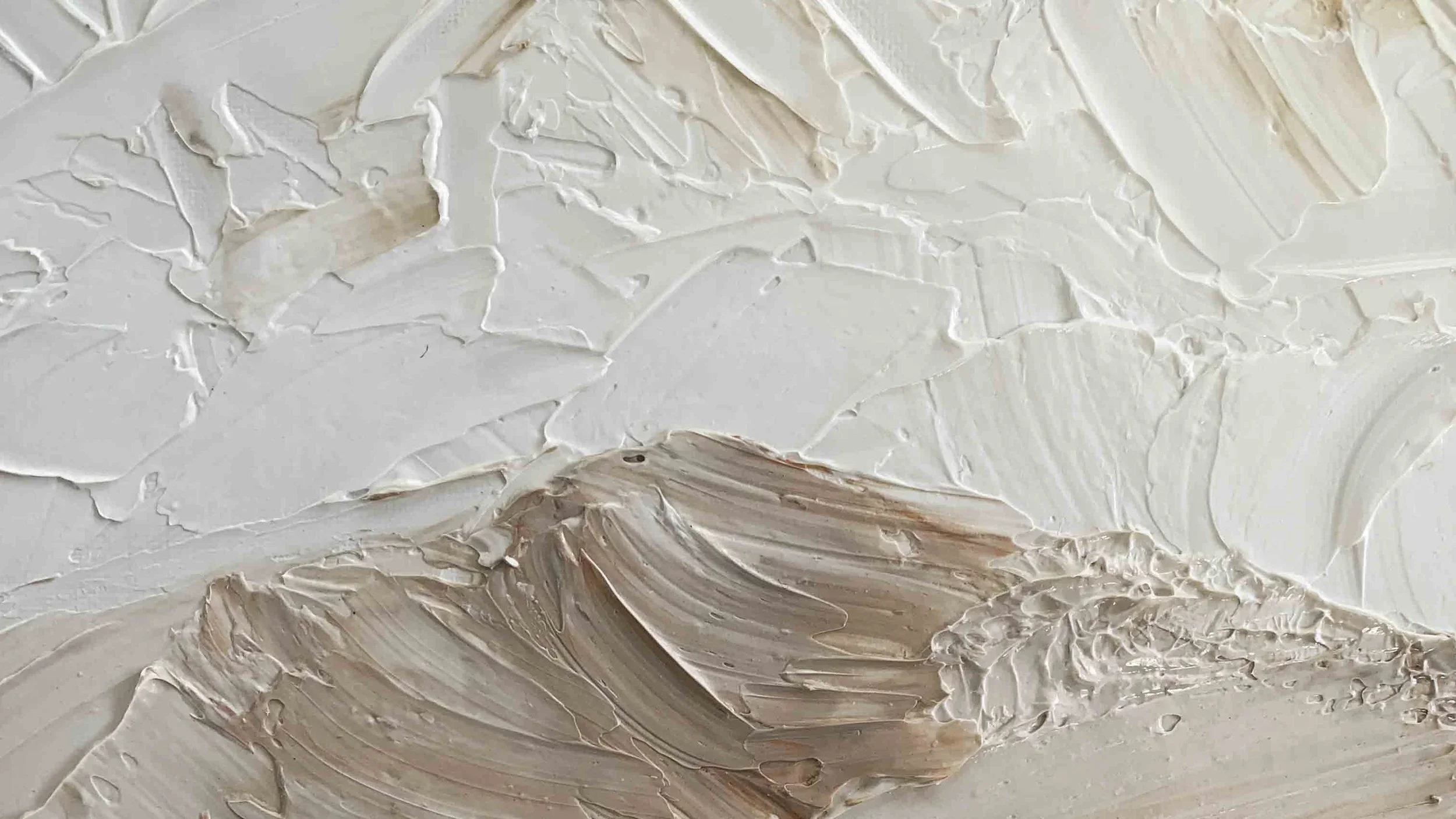 Close-up of thick, textured white and beige oil paint on canvas. The paint is applied in broad, sweeping strokes, creating an abstract, layered surface.