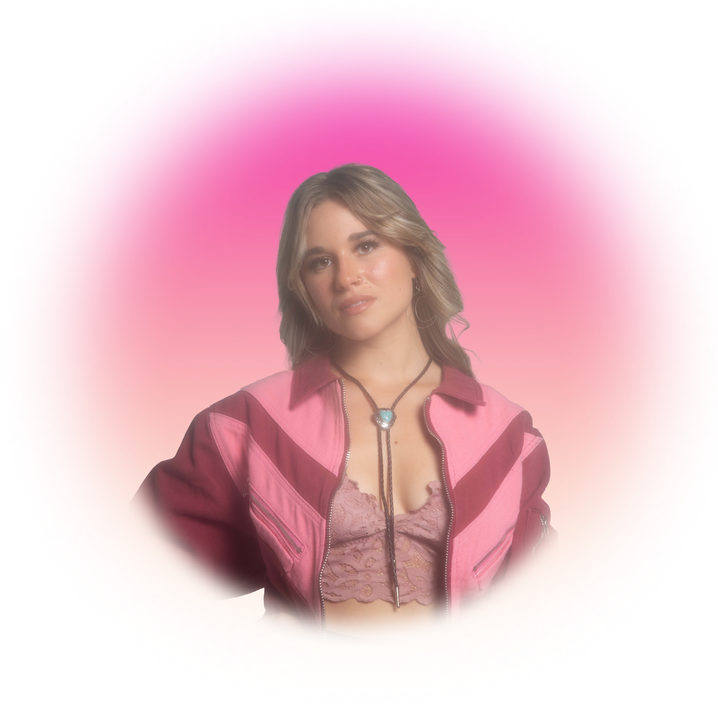Woman in pink and burgundy jacket with lace top, against vibrant gradient background.
