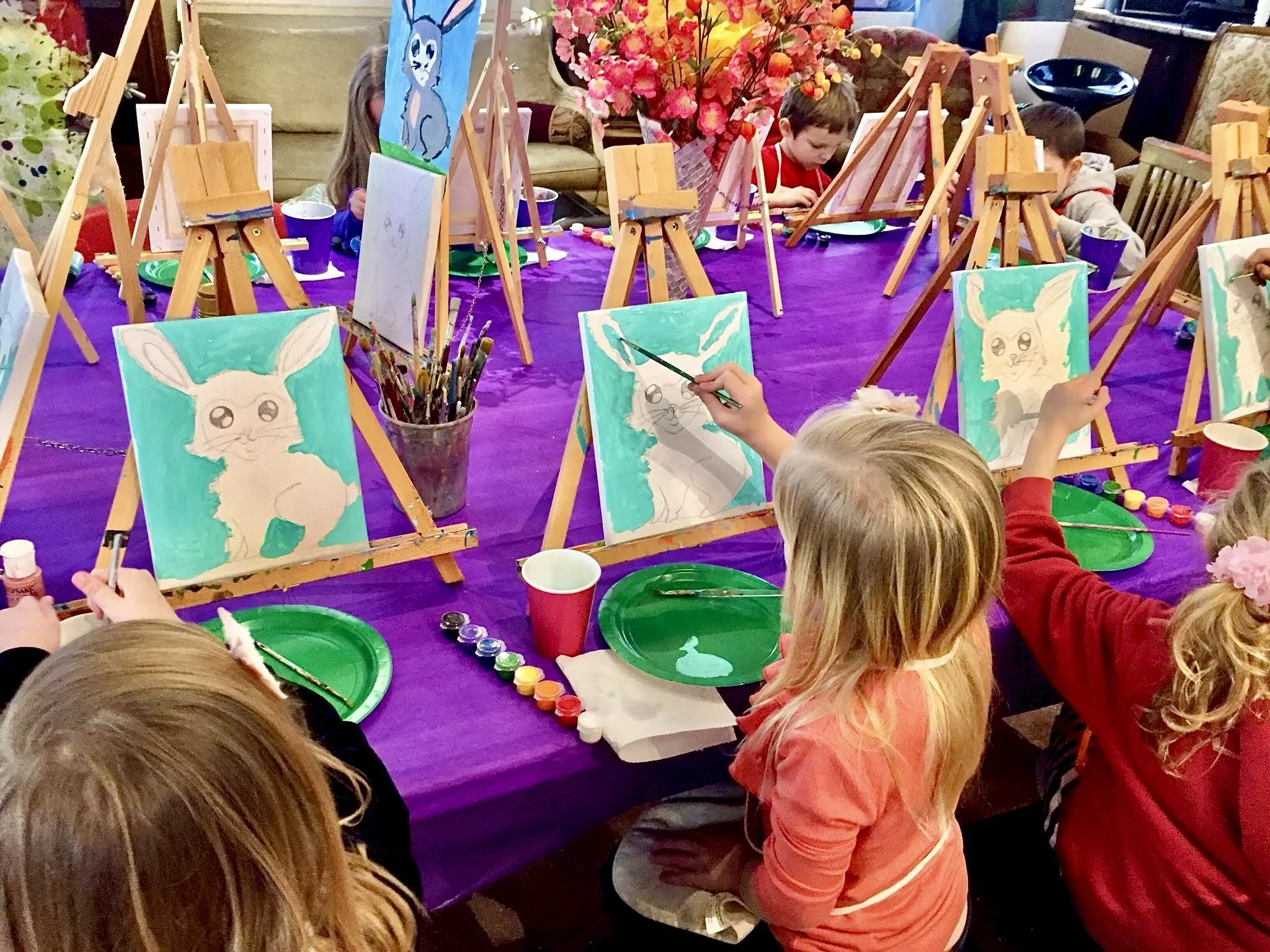 Kids painting on easels during a small group art class at Heart of Art studio in Hamilton, NJ