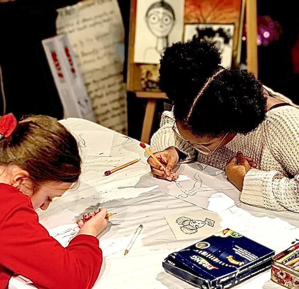Kids working together on manga and anime drawing projects in a small art class setting at the Heart of Art in Hamilton, NJ
