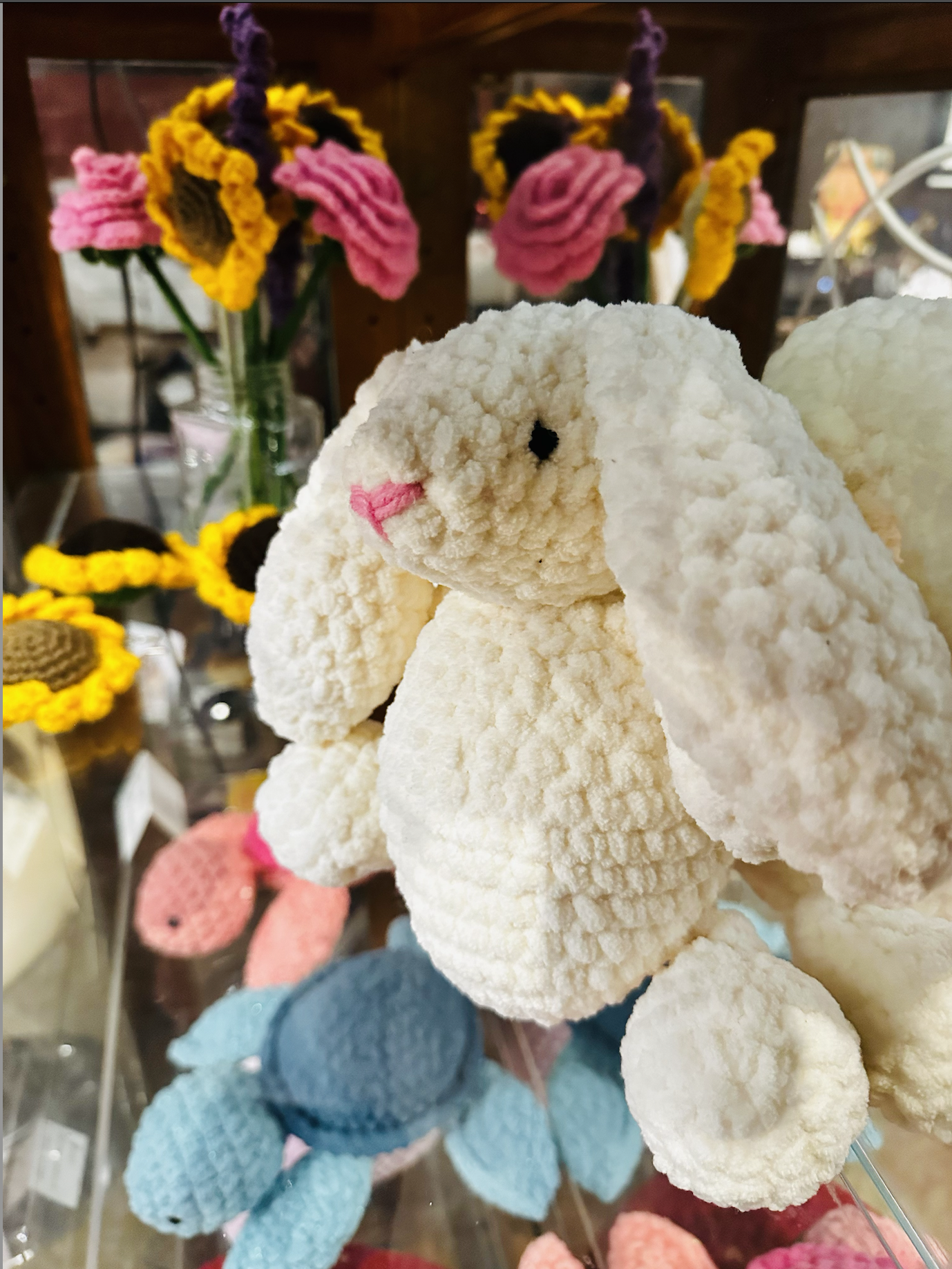 Handmade crochet stuffed bunny made by the teacher and displayed as an example project from an advanced crochet class.