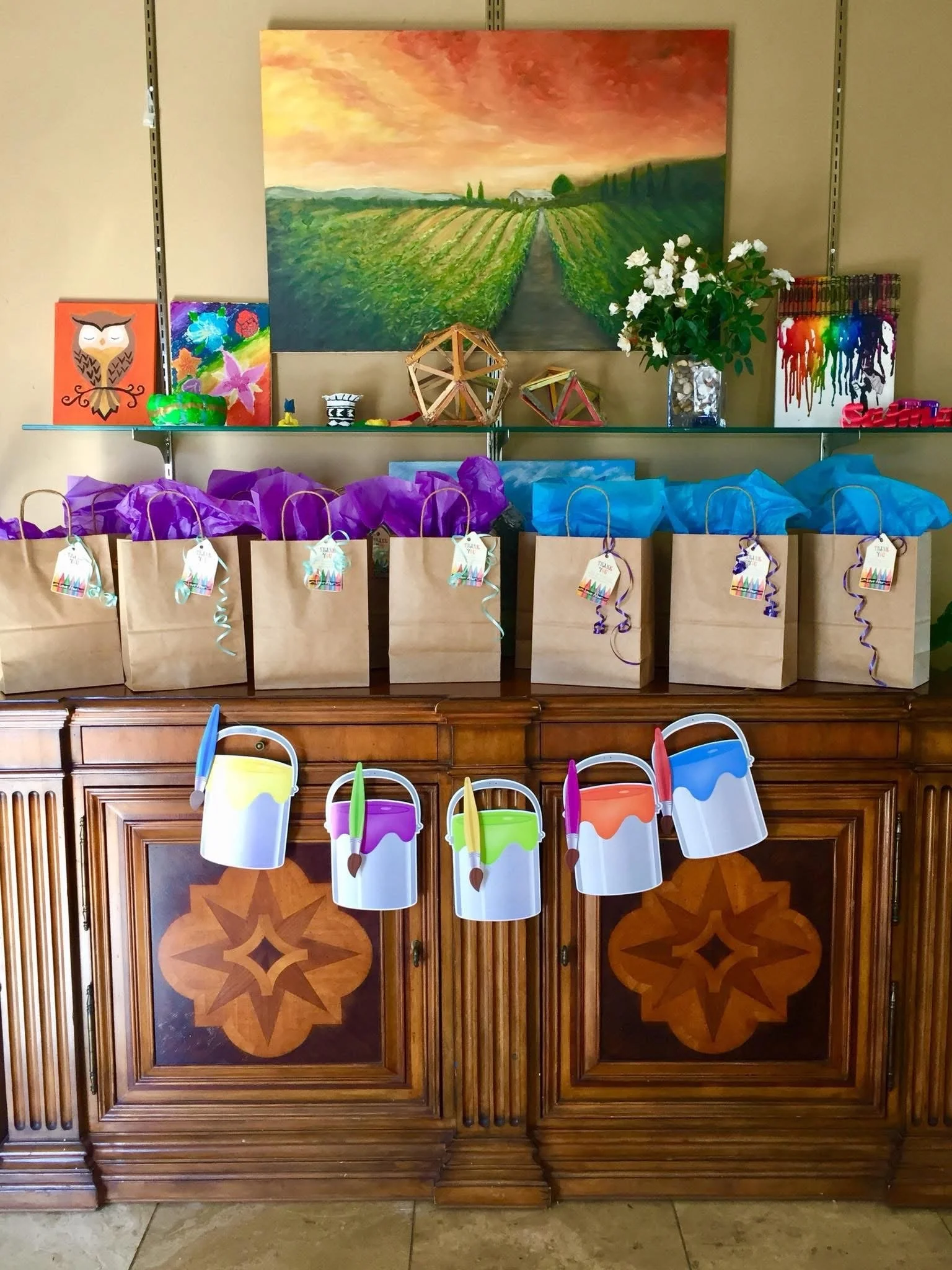 Glow-themed goodie bags setup set up aesthetically, for kids at a glow paint birthday party