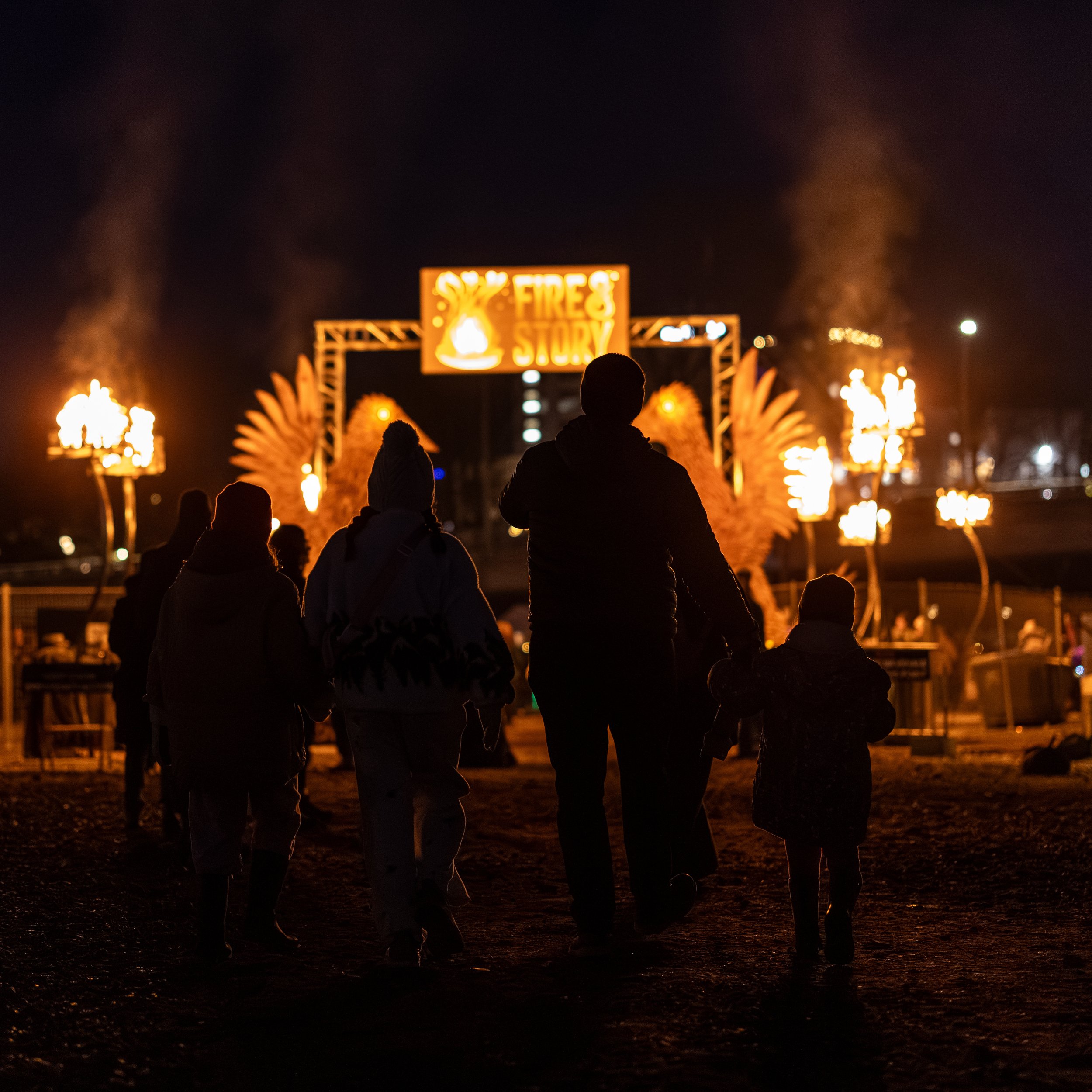 Family walks up a pathway to Fire & Story festival at the Bellingham Waterfront.
