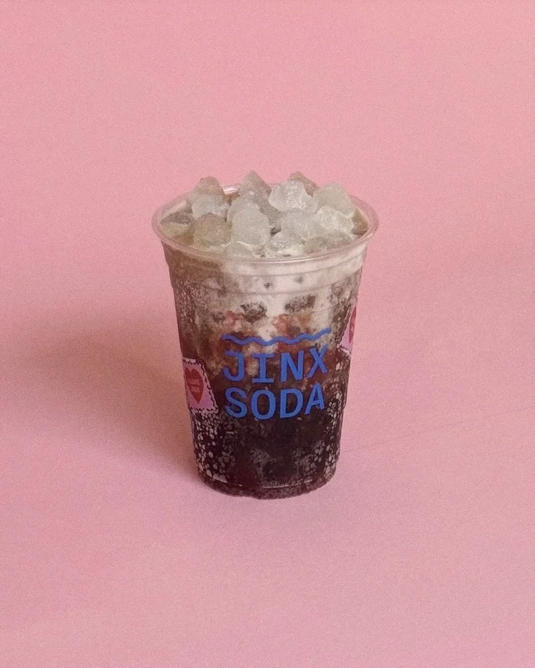 A Dr Pepper based dirty soda with half and half raspberry puree and coconut syrup