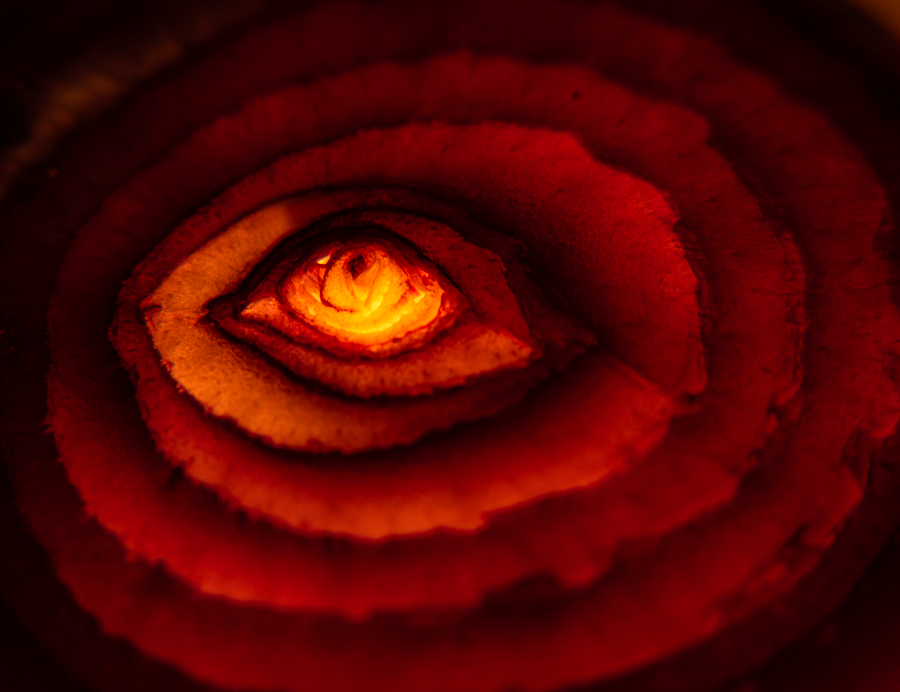 Abstract artwork titled Crimson Dawn by Nahid Naderi, featuring deep crimson hues with a central golden light, symbolizing inner awakening and unity like a sunrise.